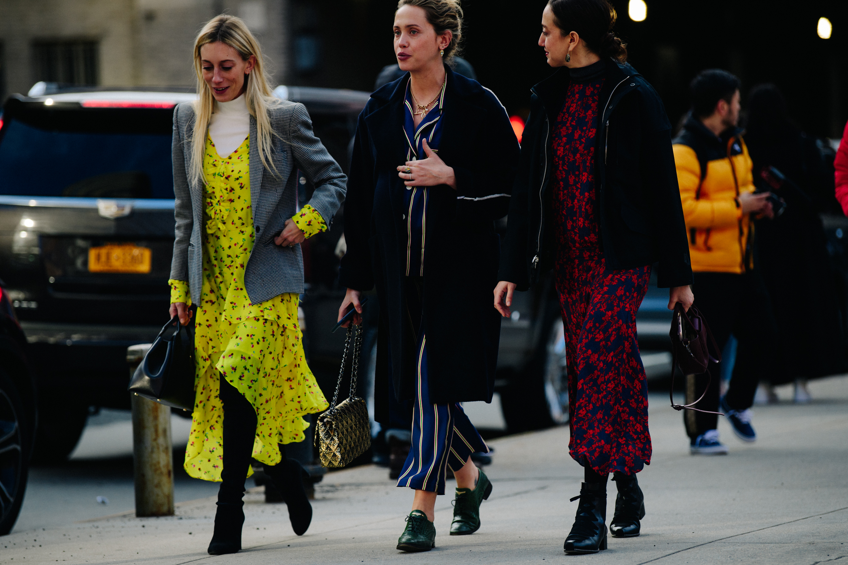 Three women wearing colourful coats