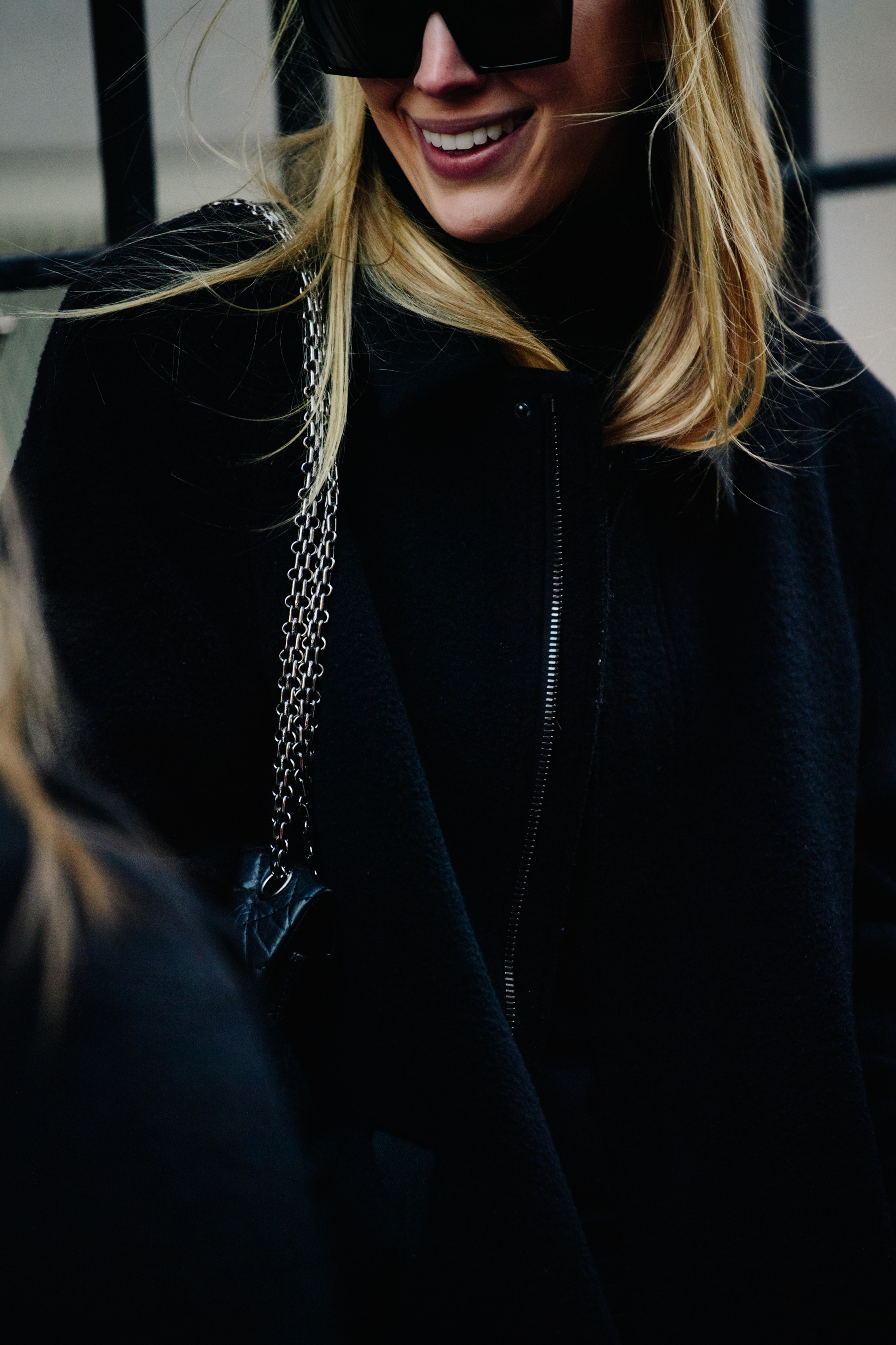 Woman wearing thick black sunglasses