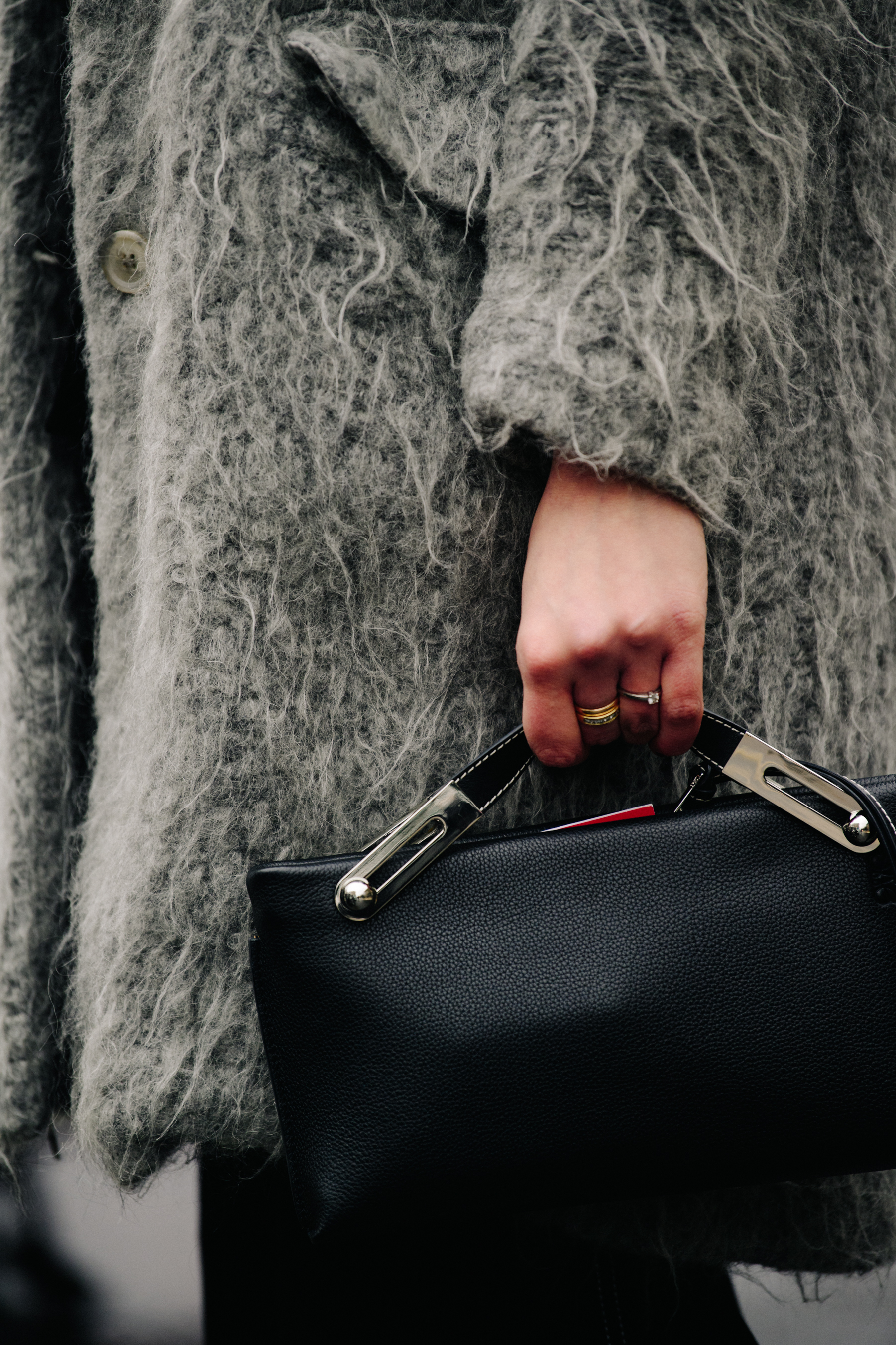 Woman holding black leather bag