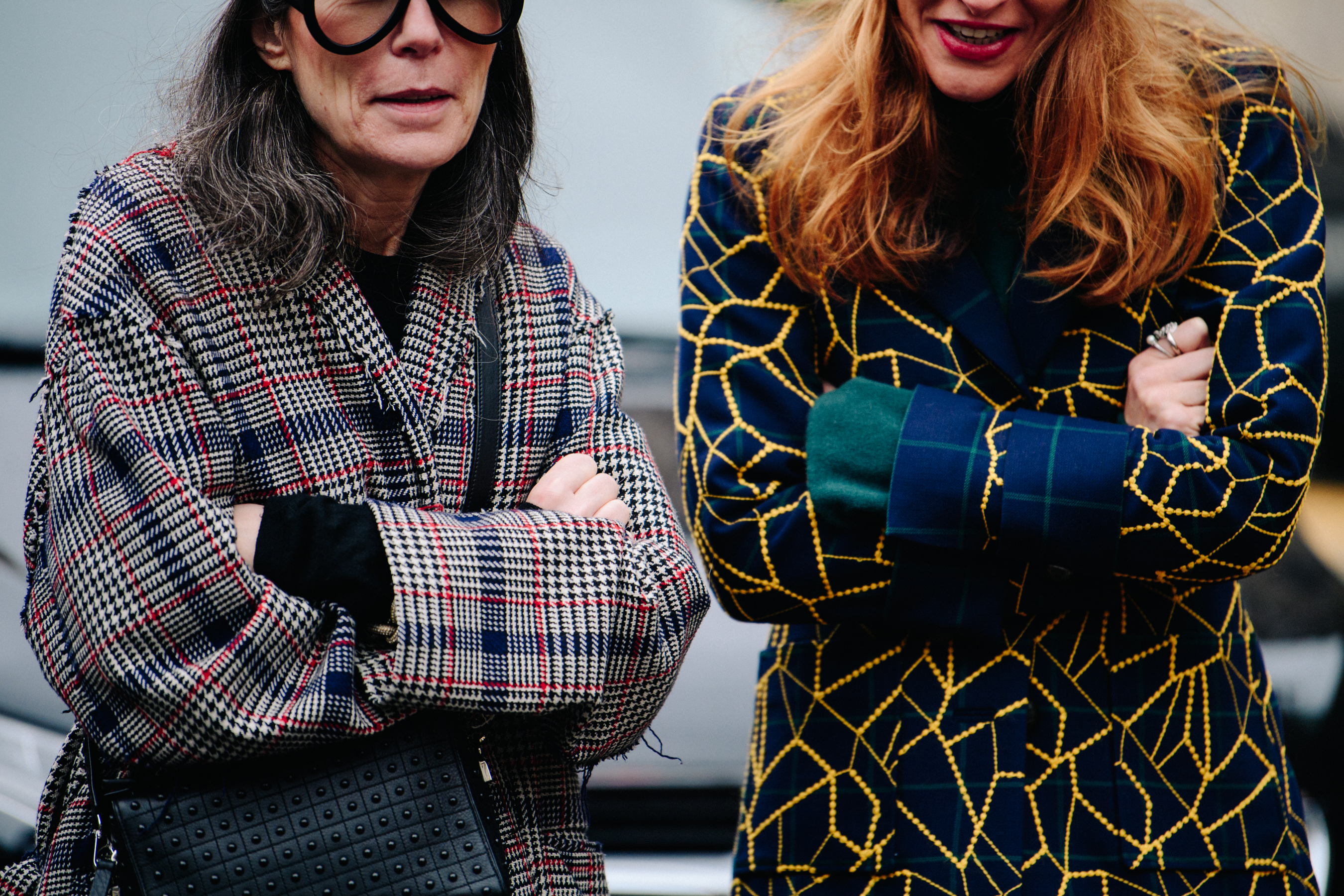 Two women wearing pattern wool coats