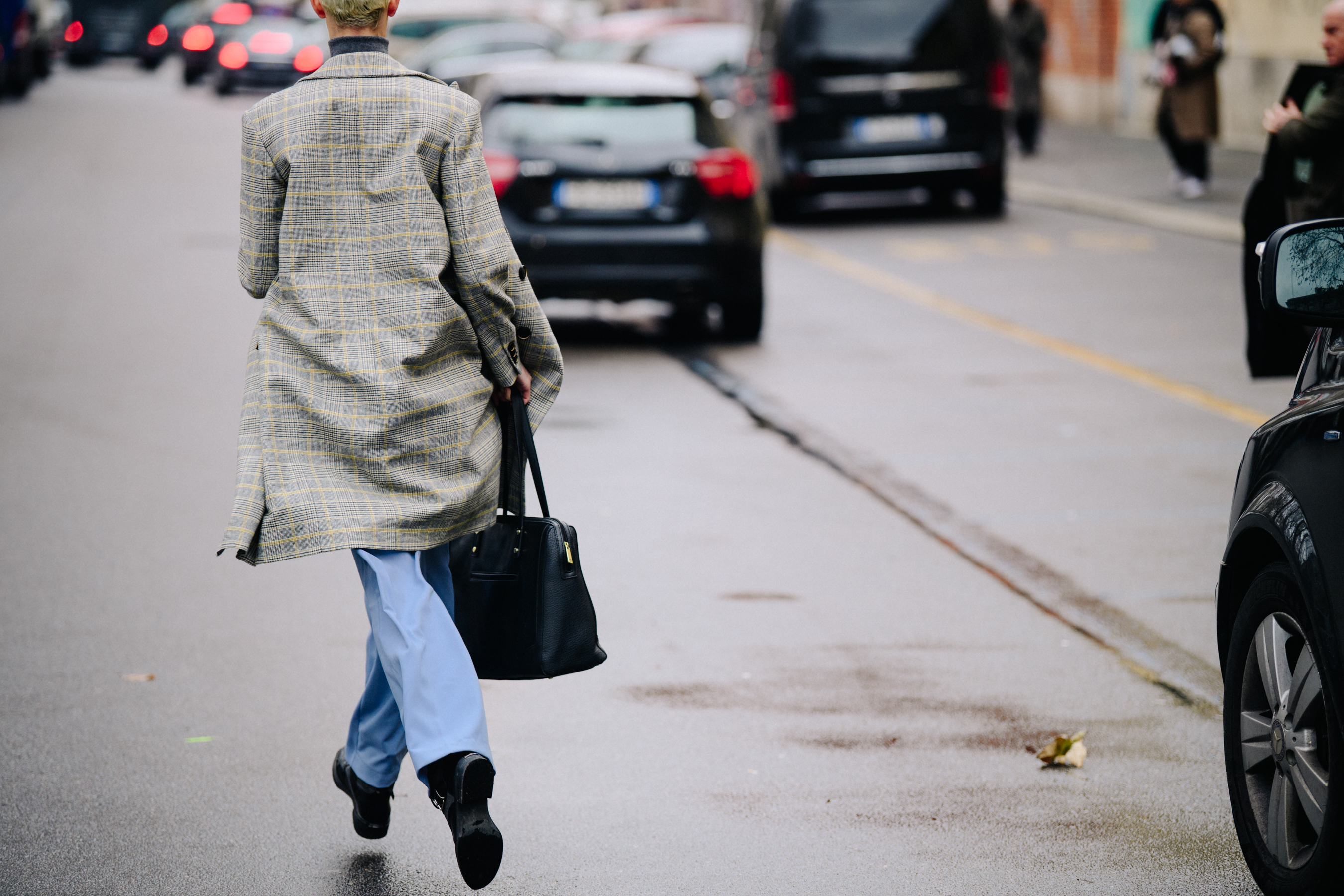 Woman running in check coat