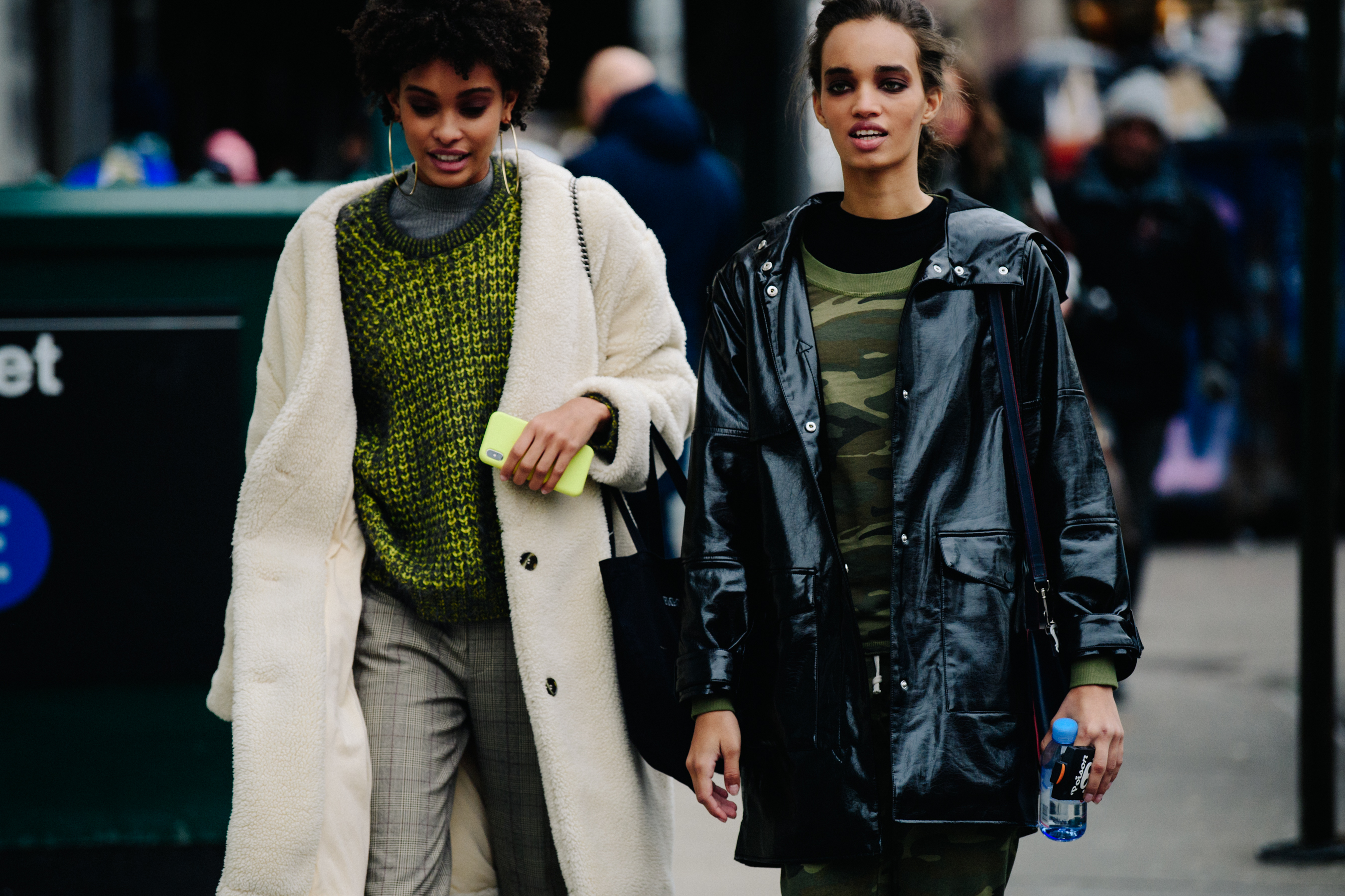 Two model wearing green jumpers