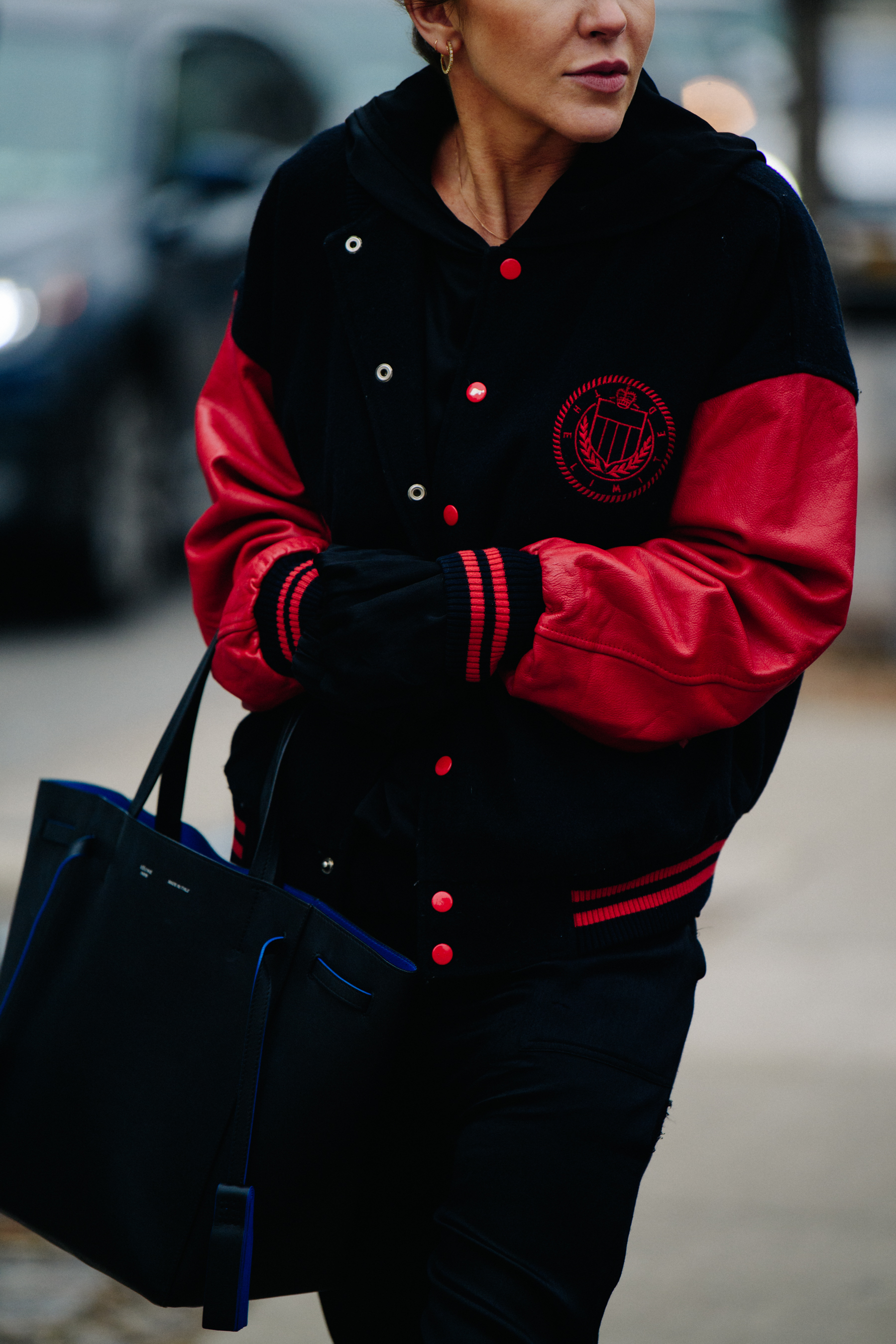 Woman wearing black and red varsity jacket