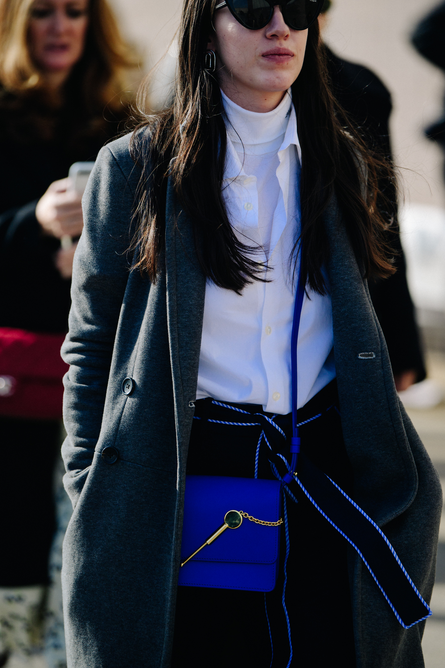 Woman wearing blue handbag