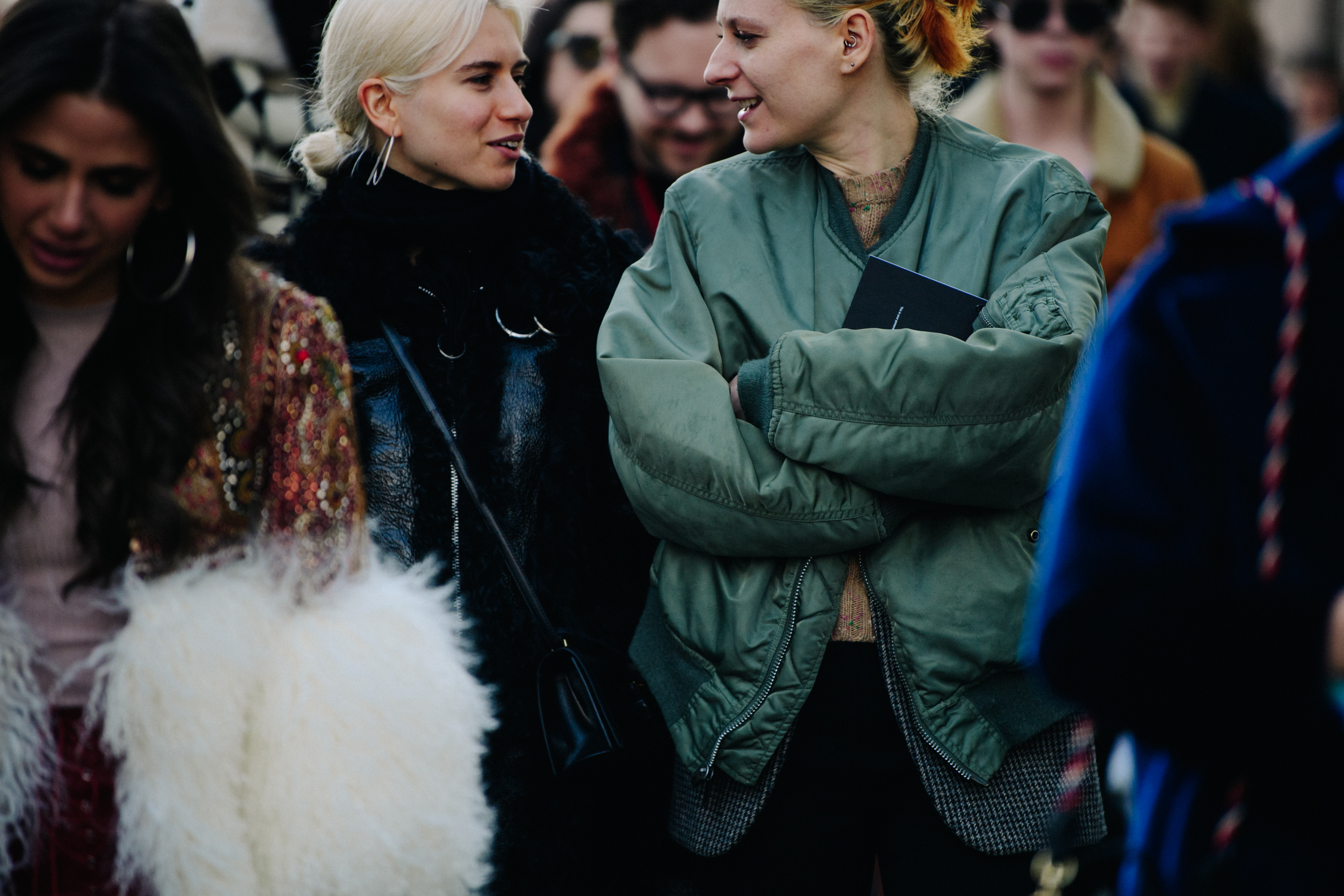 Two women wearing dark jackets