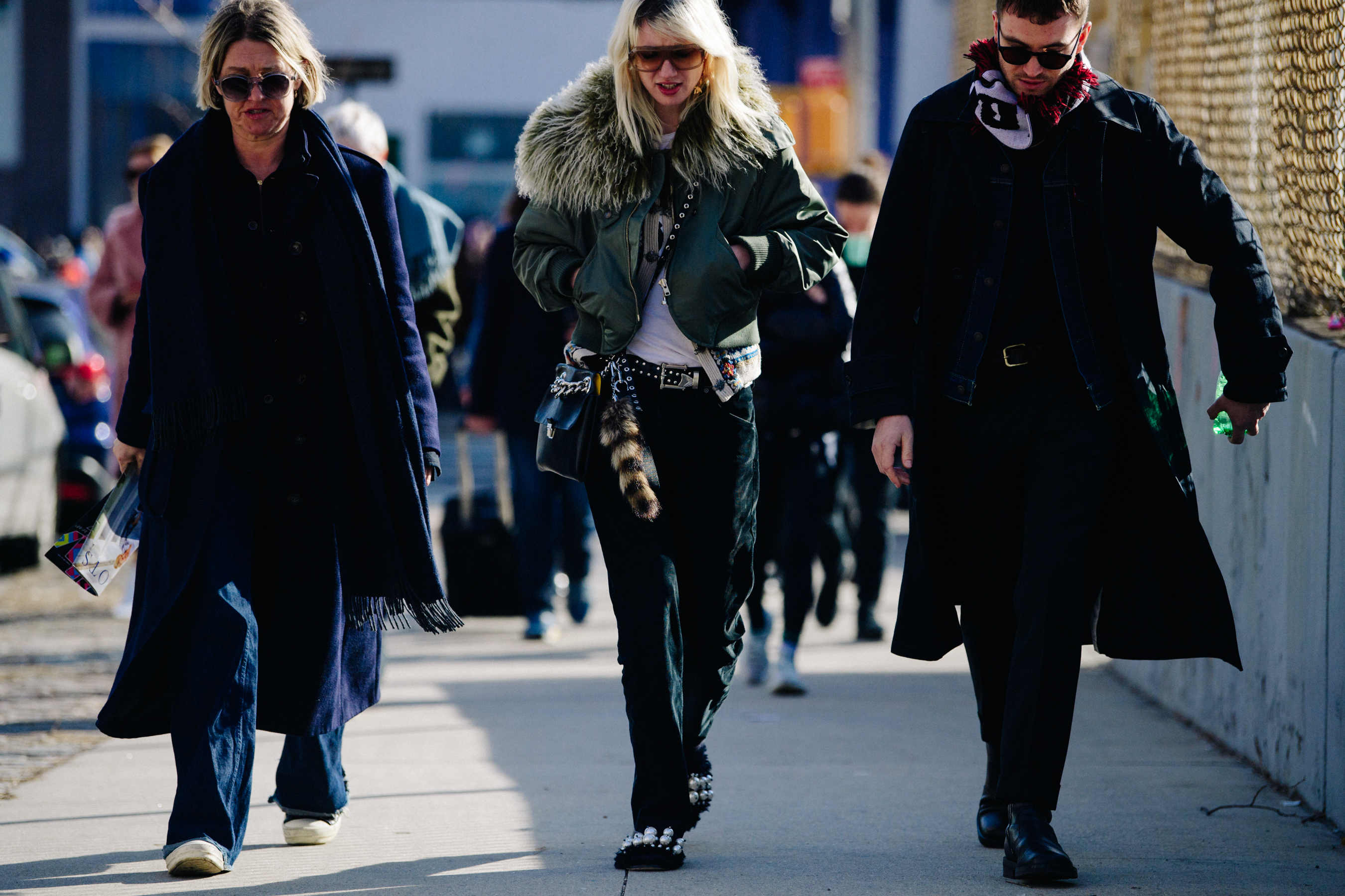 Three people wearing winter coats