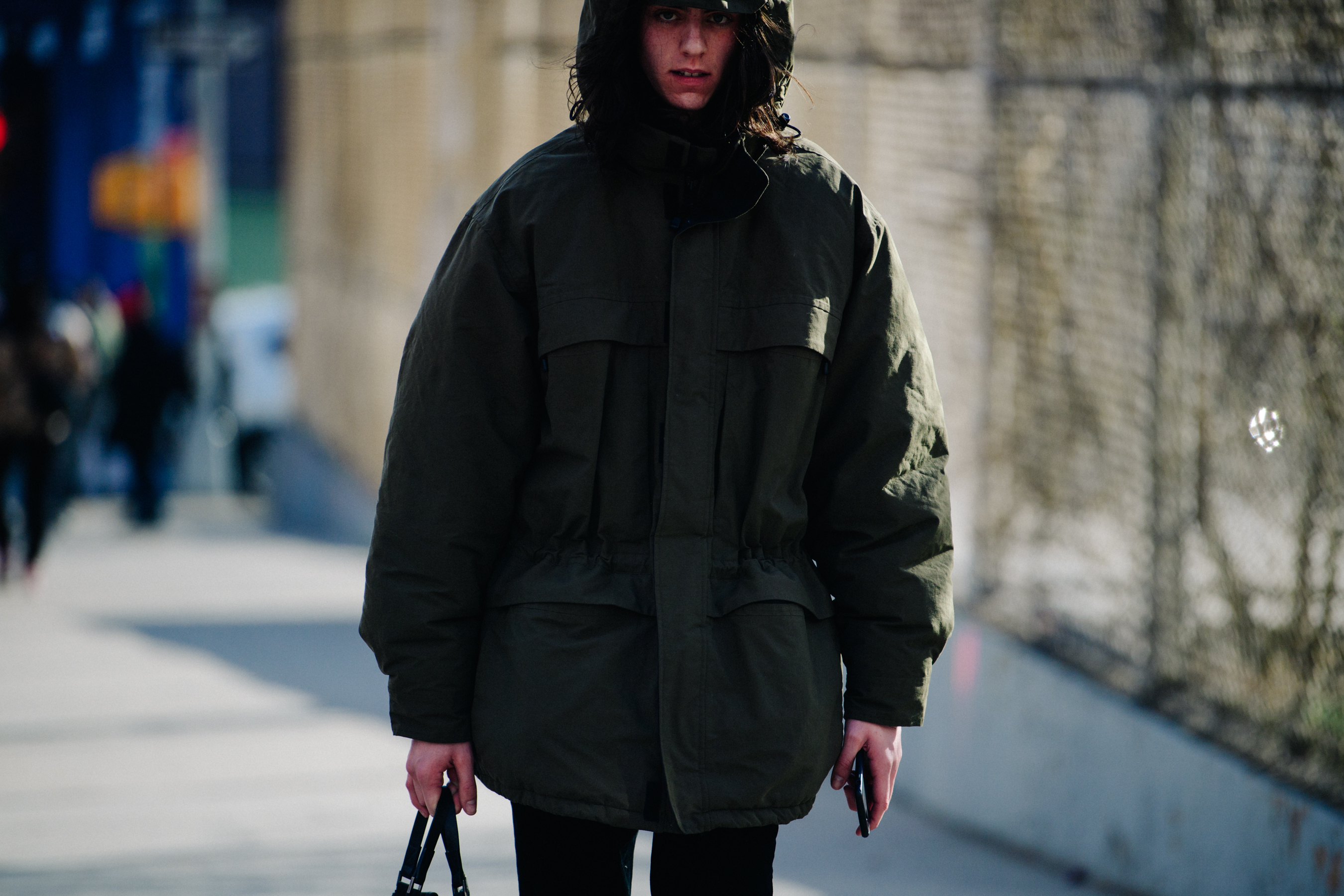 Model wearing green coat with hood