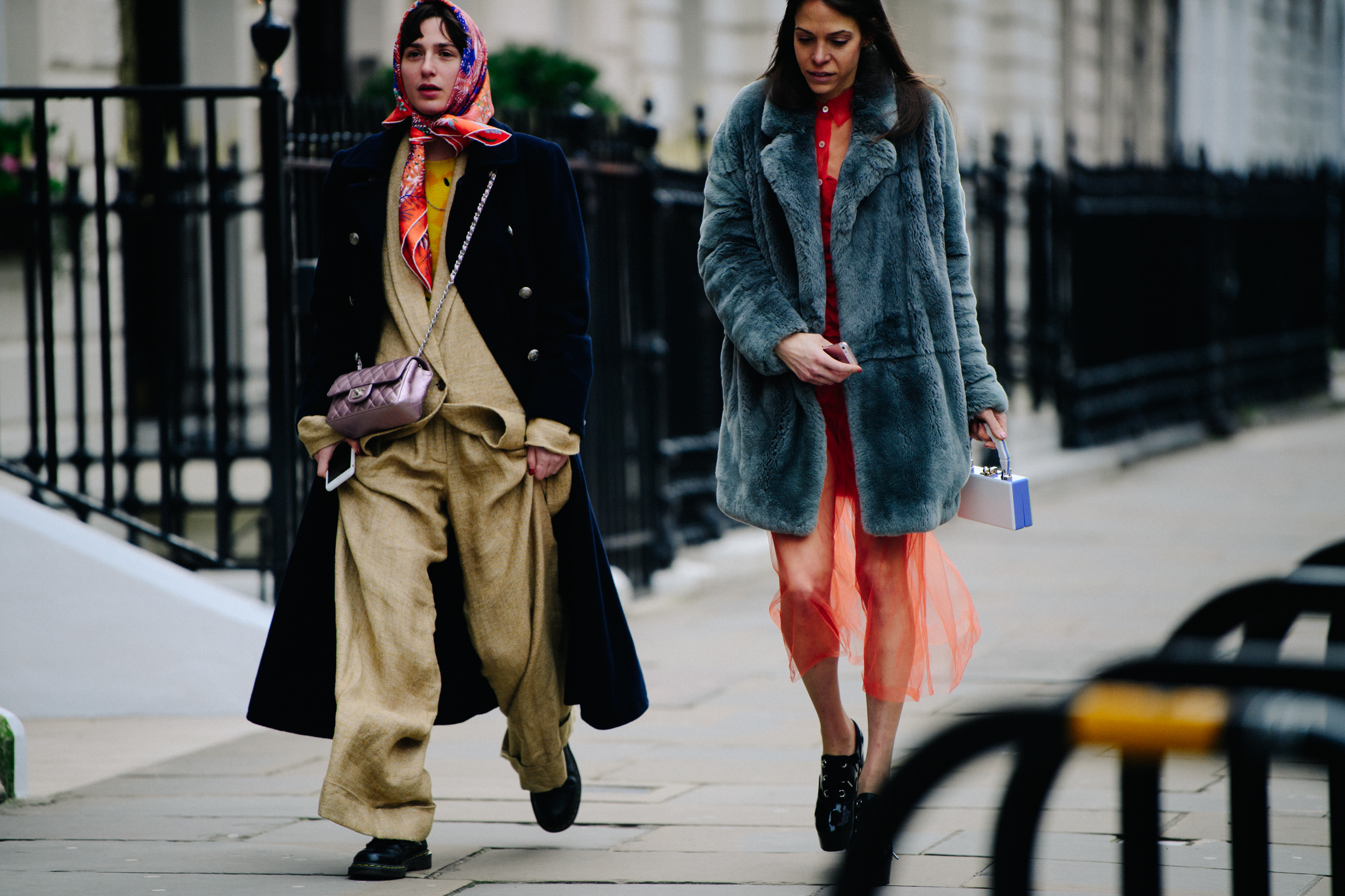 Two women wearing long dark outfits