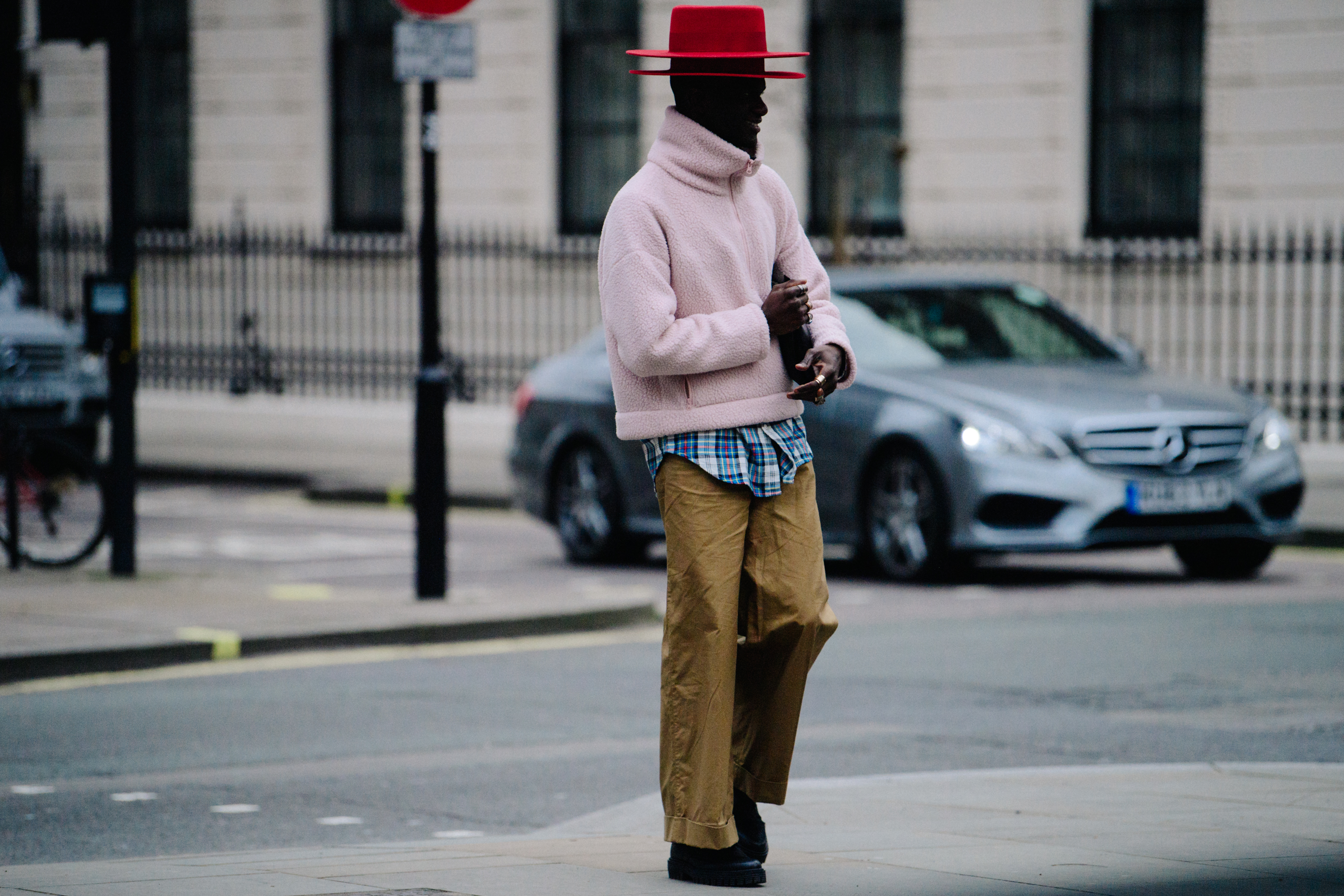 Man wearing two red hats