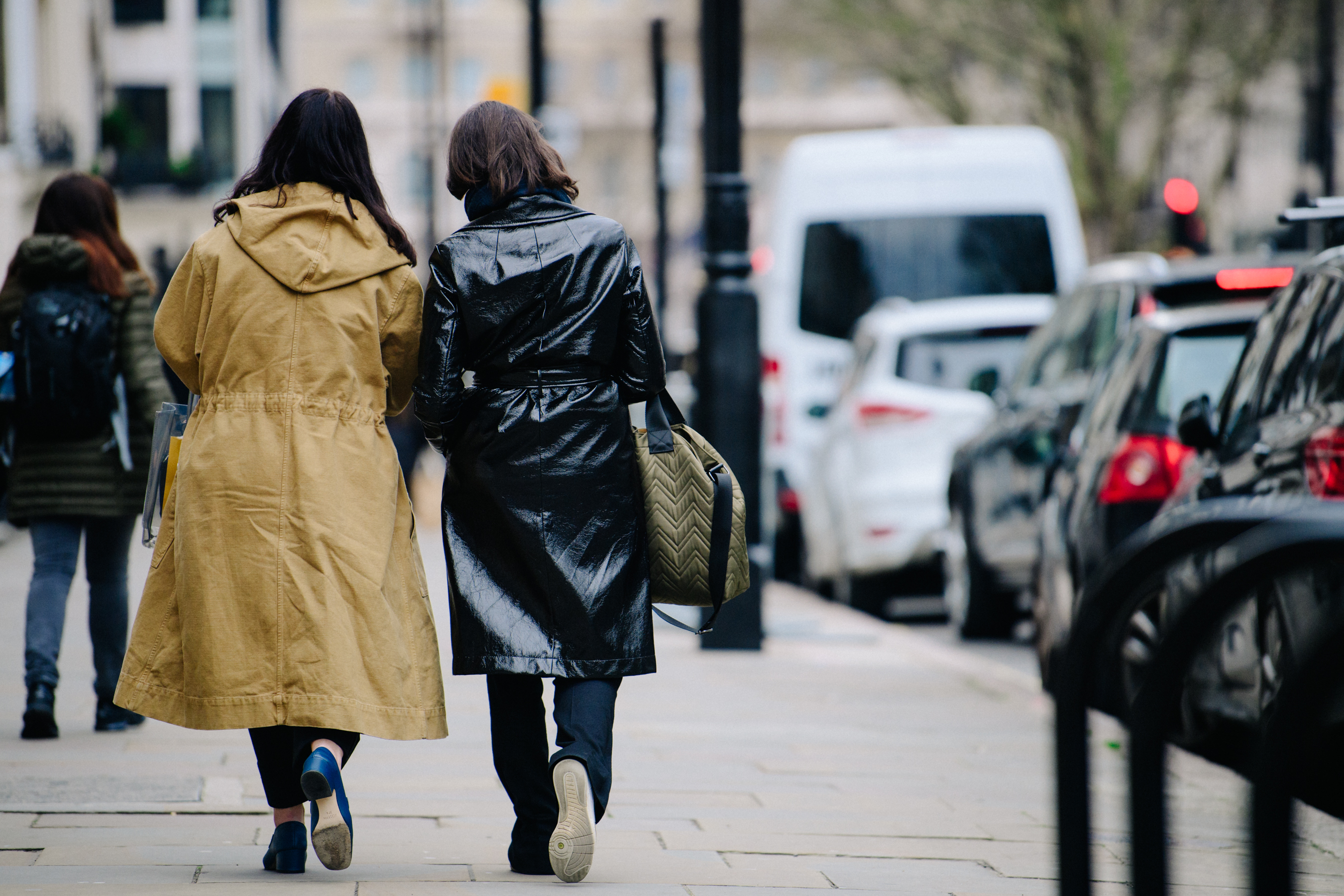 Two women wearing black and tan