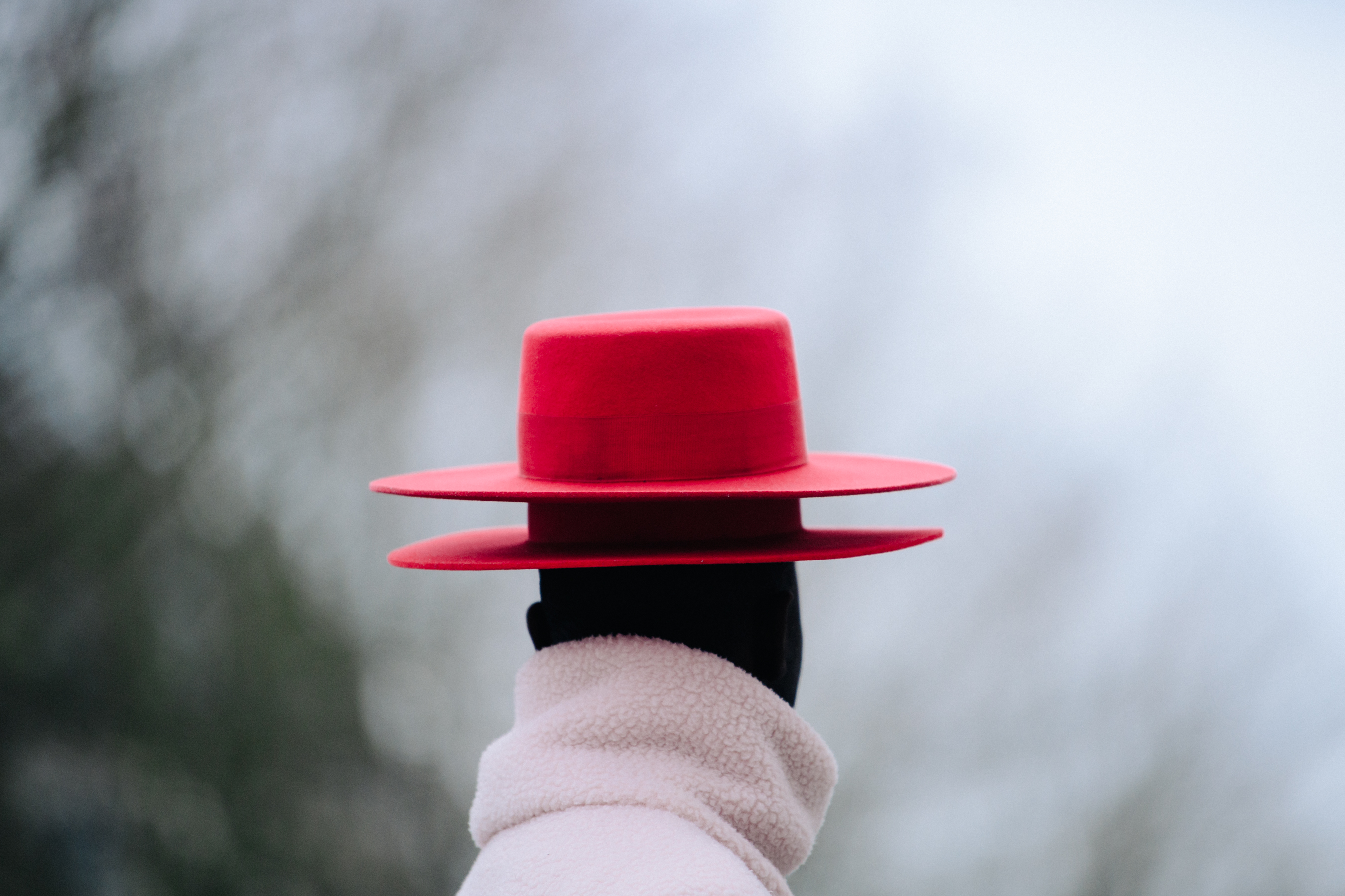 Man wearing two red hats