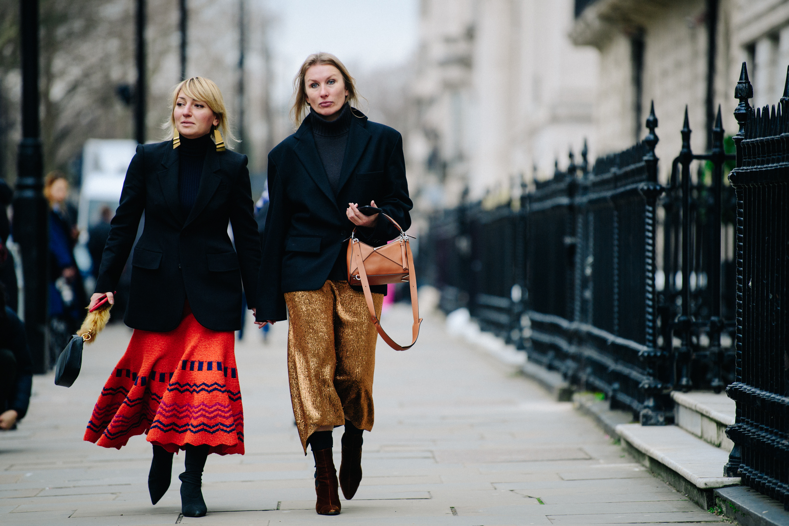 Two women wearing black suit jackets