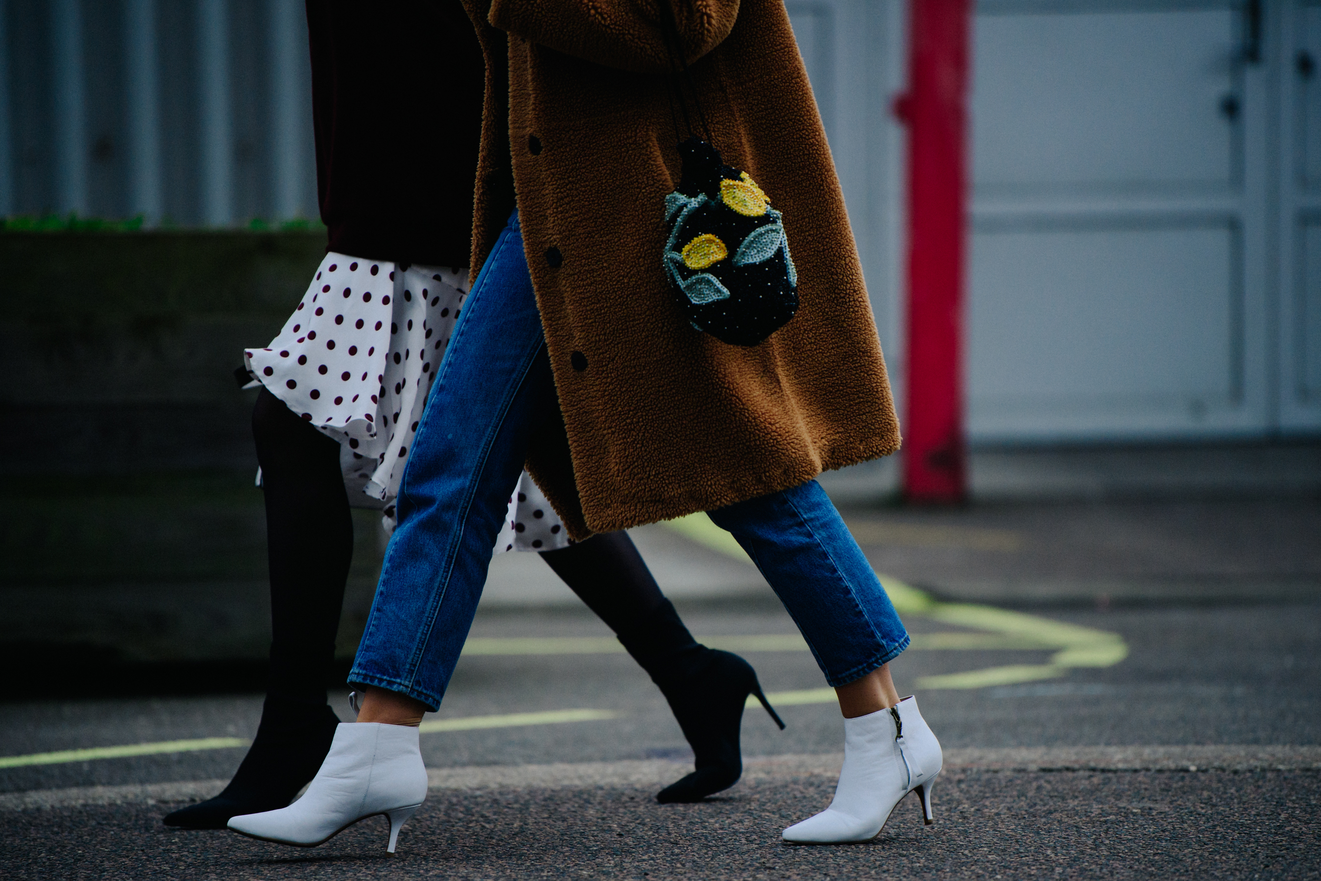 Two women wearing black and white heels