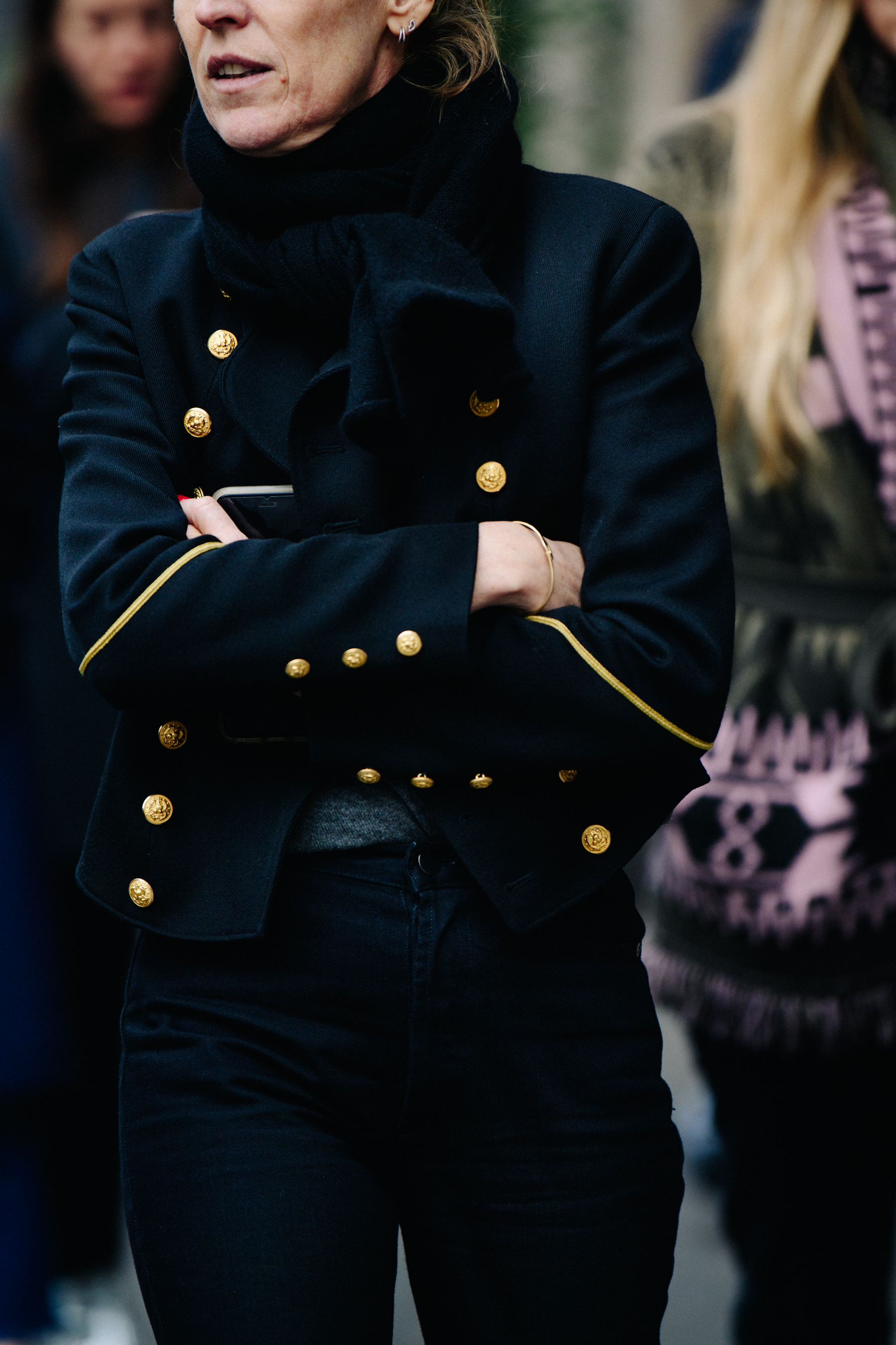 Woman wearing gold trim coat
