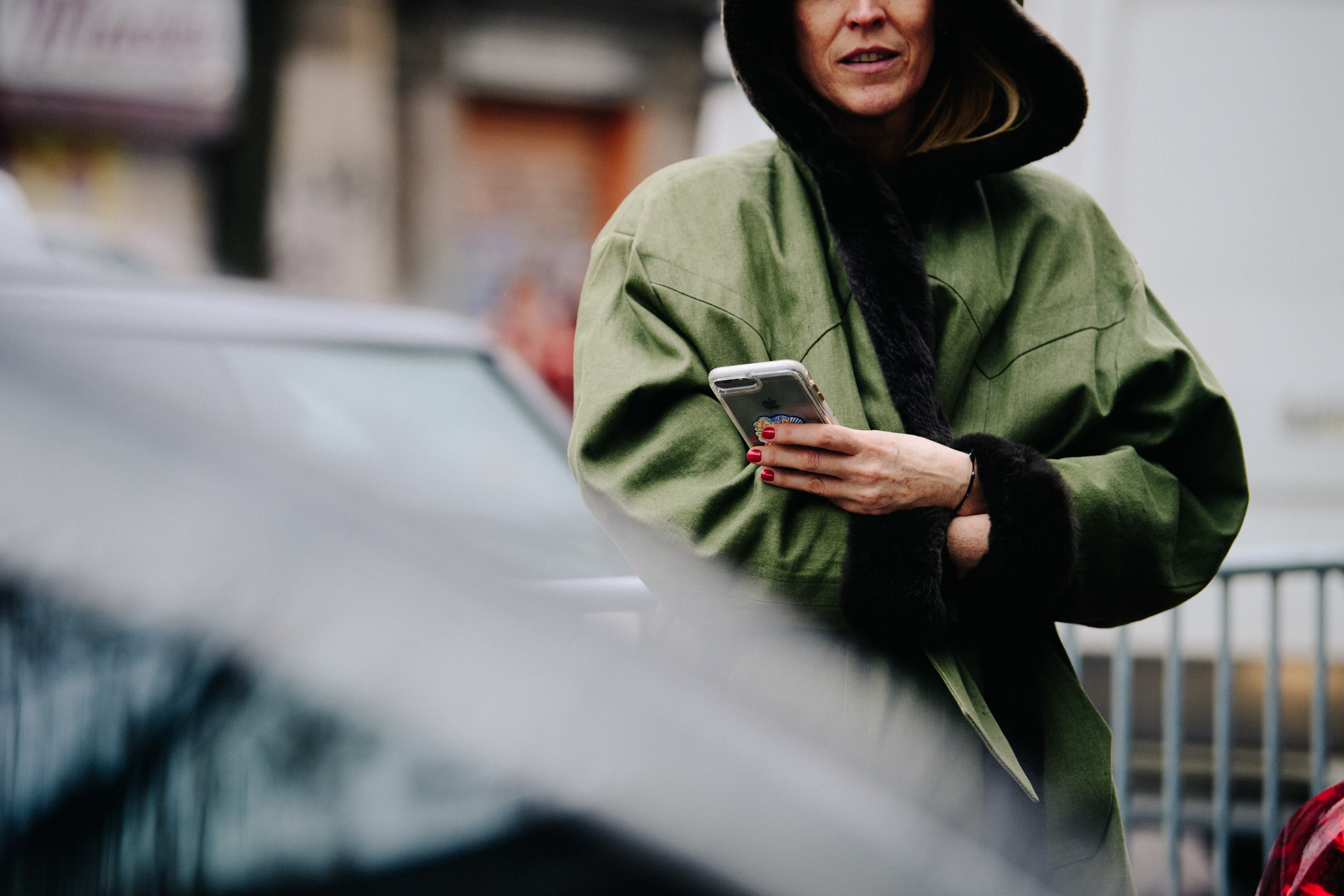 Woman wearing green and fur coat