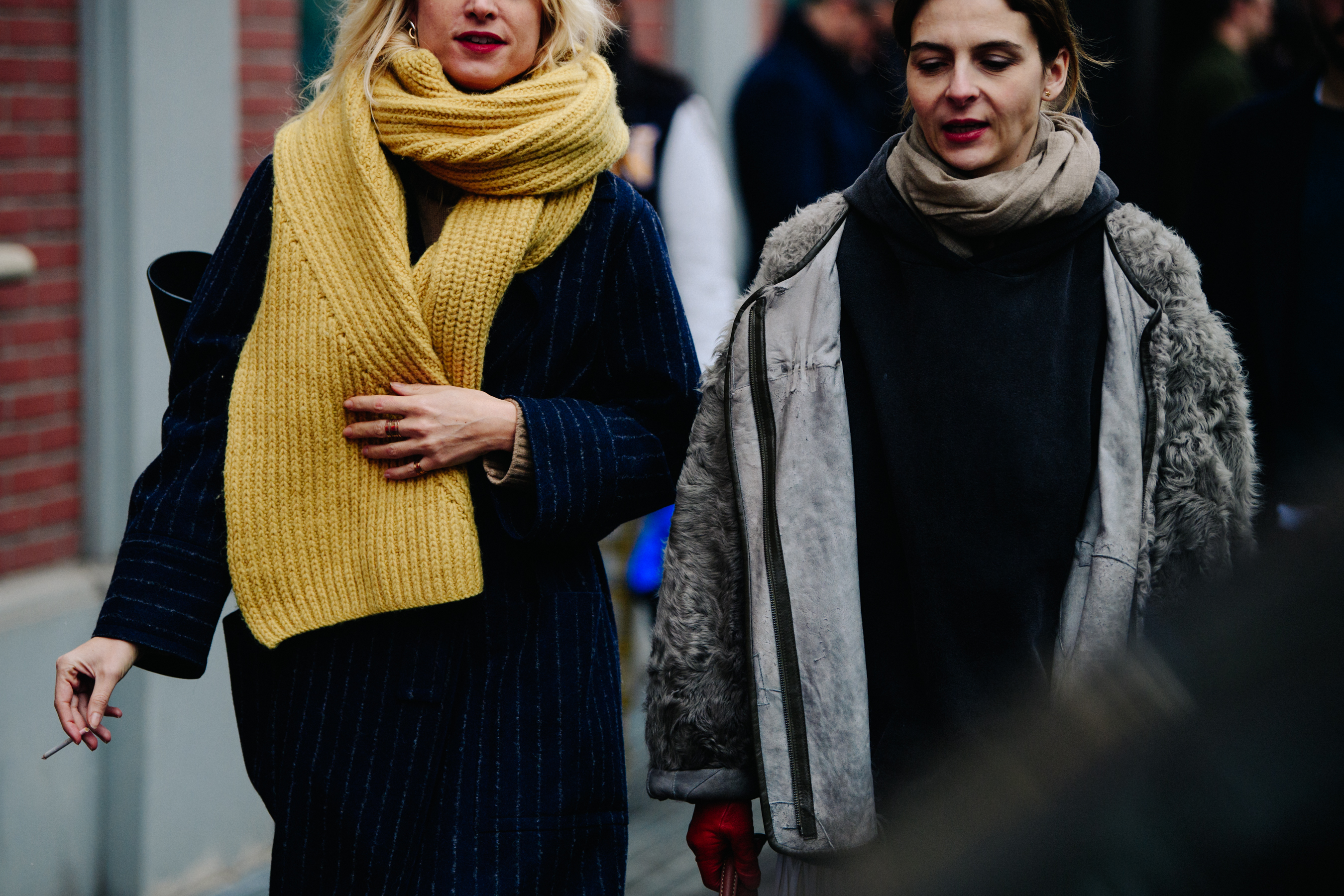 Two women wearing winter scarves