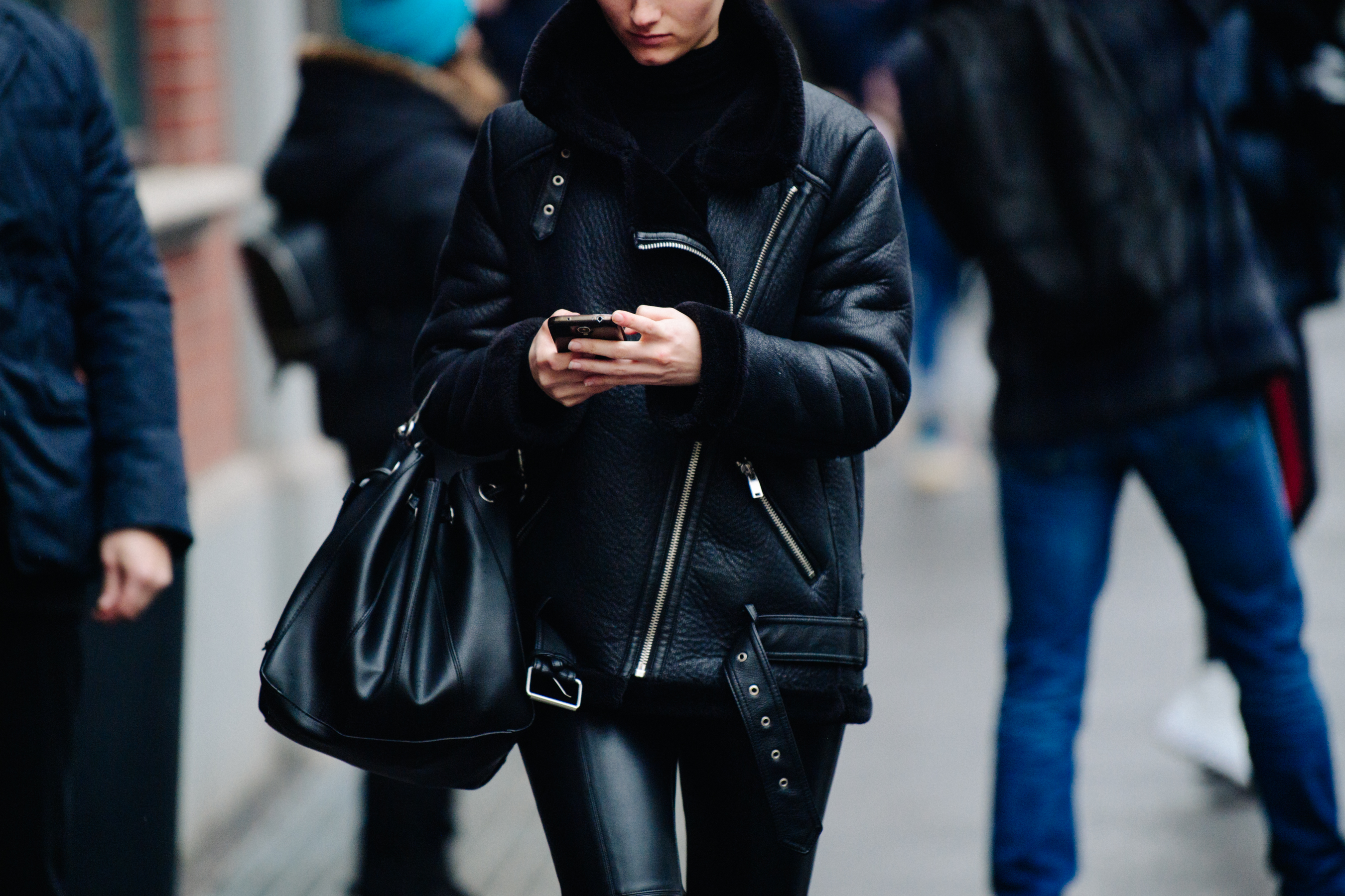 Woman wearing black shearling jacket