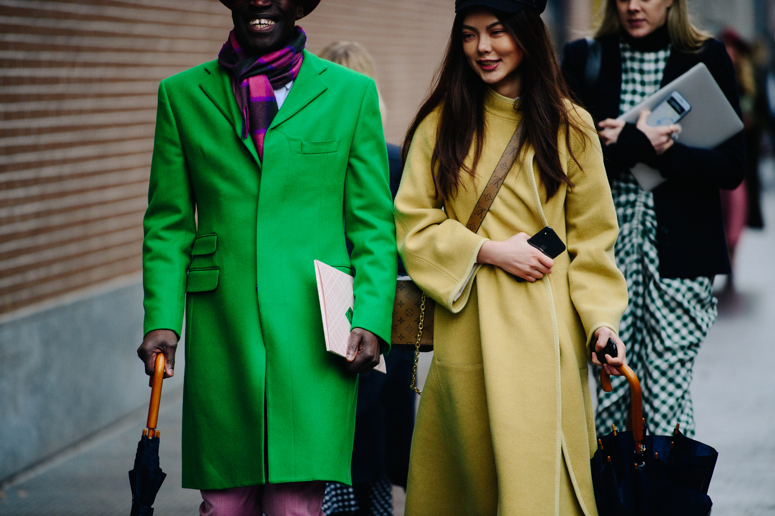 Couple wearing yellow and green coats