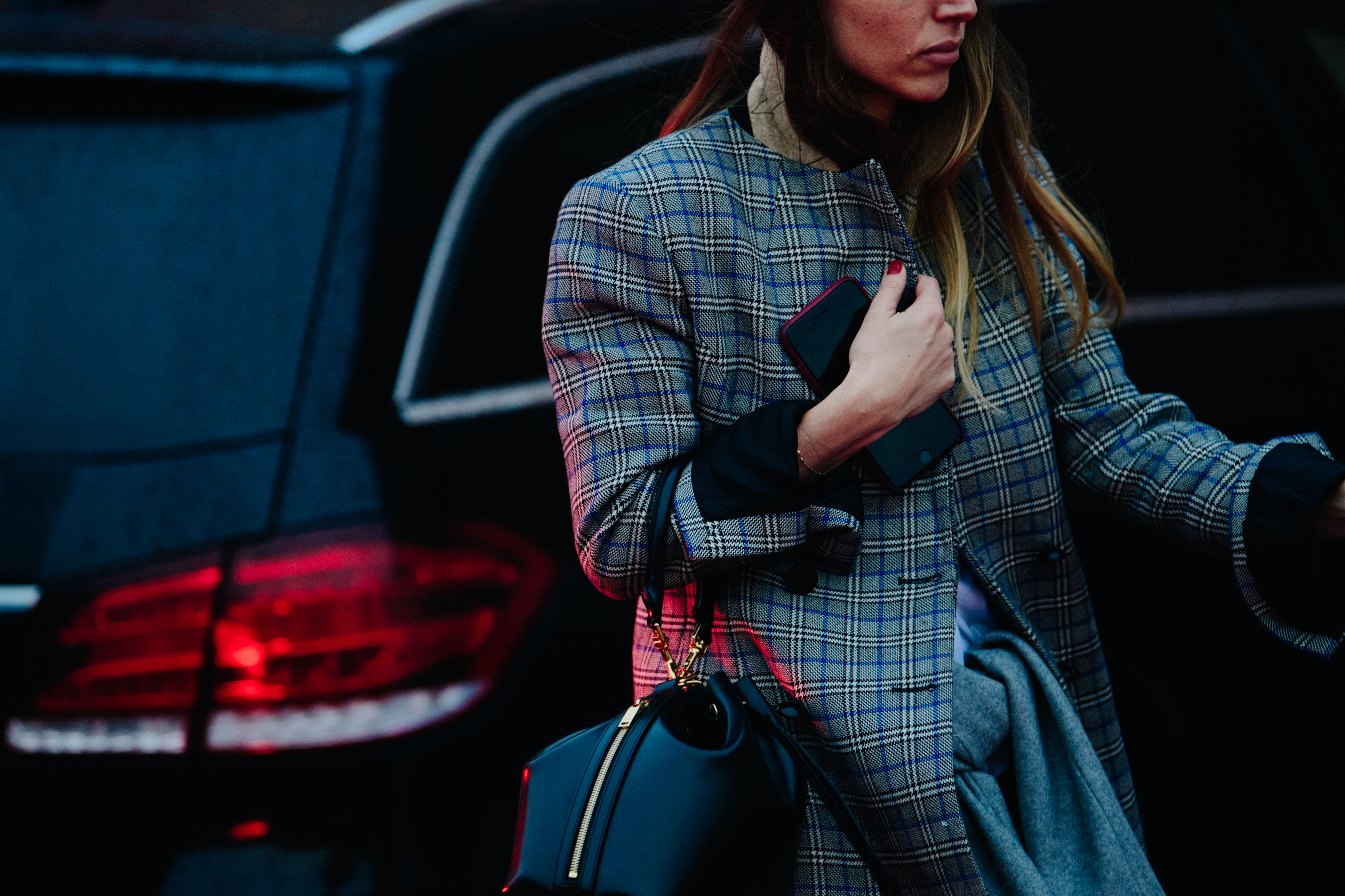 Woman wearing grey and blue check coat