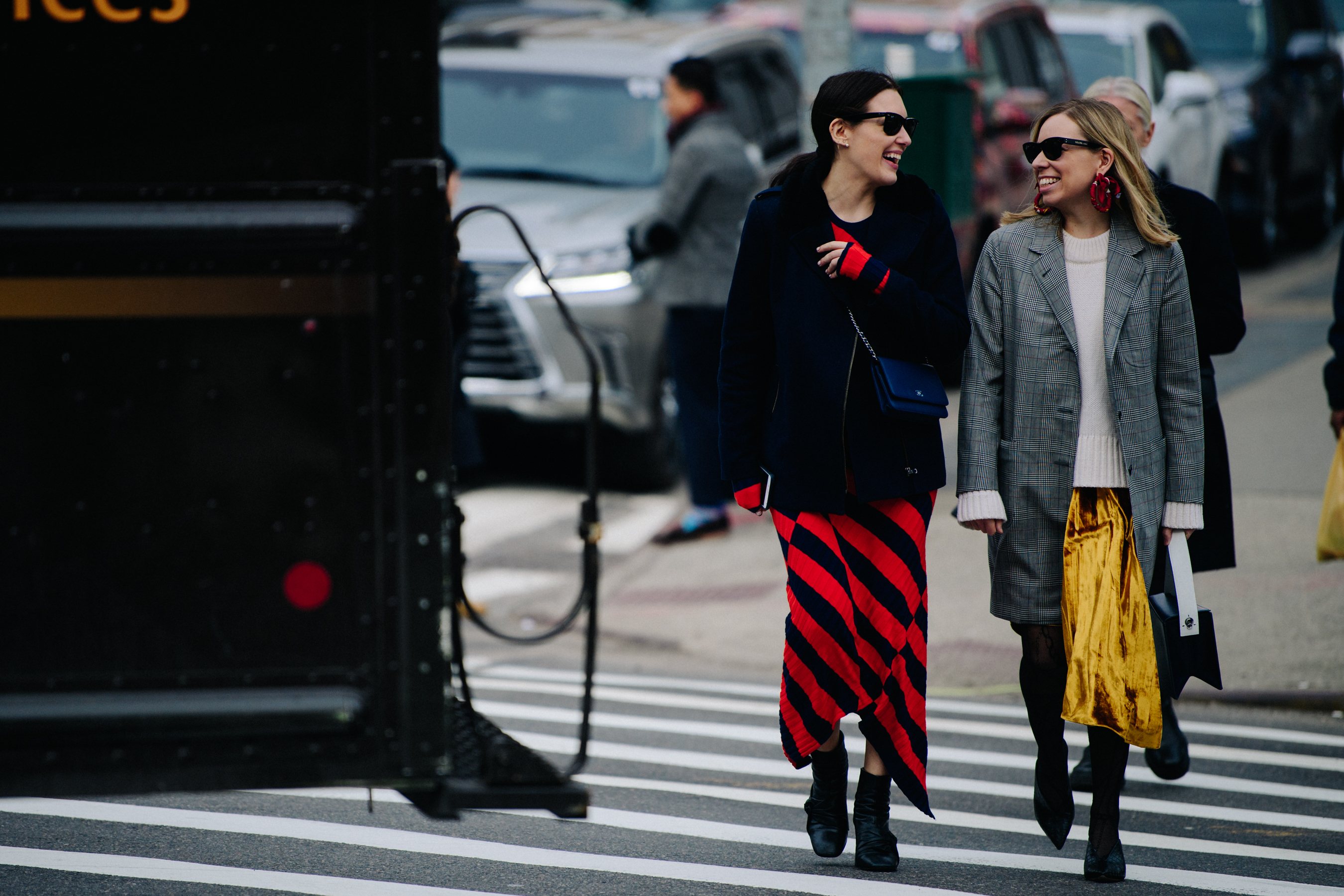 Two women wearing red and gold