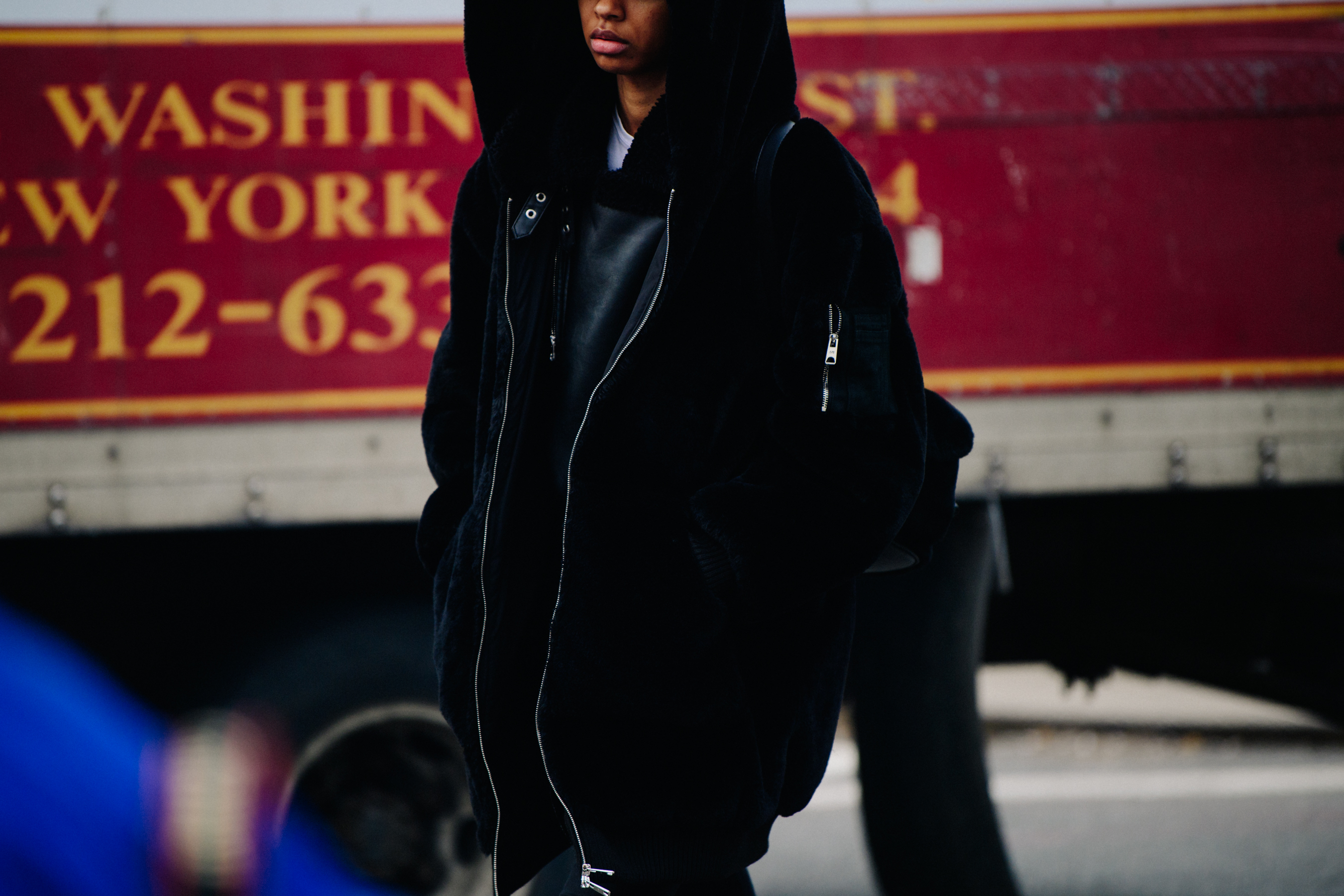Model wearing long black shearling jacket