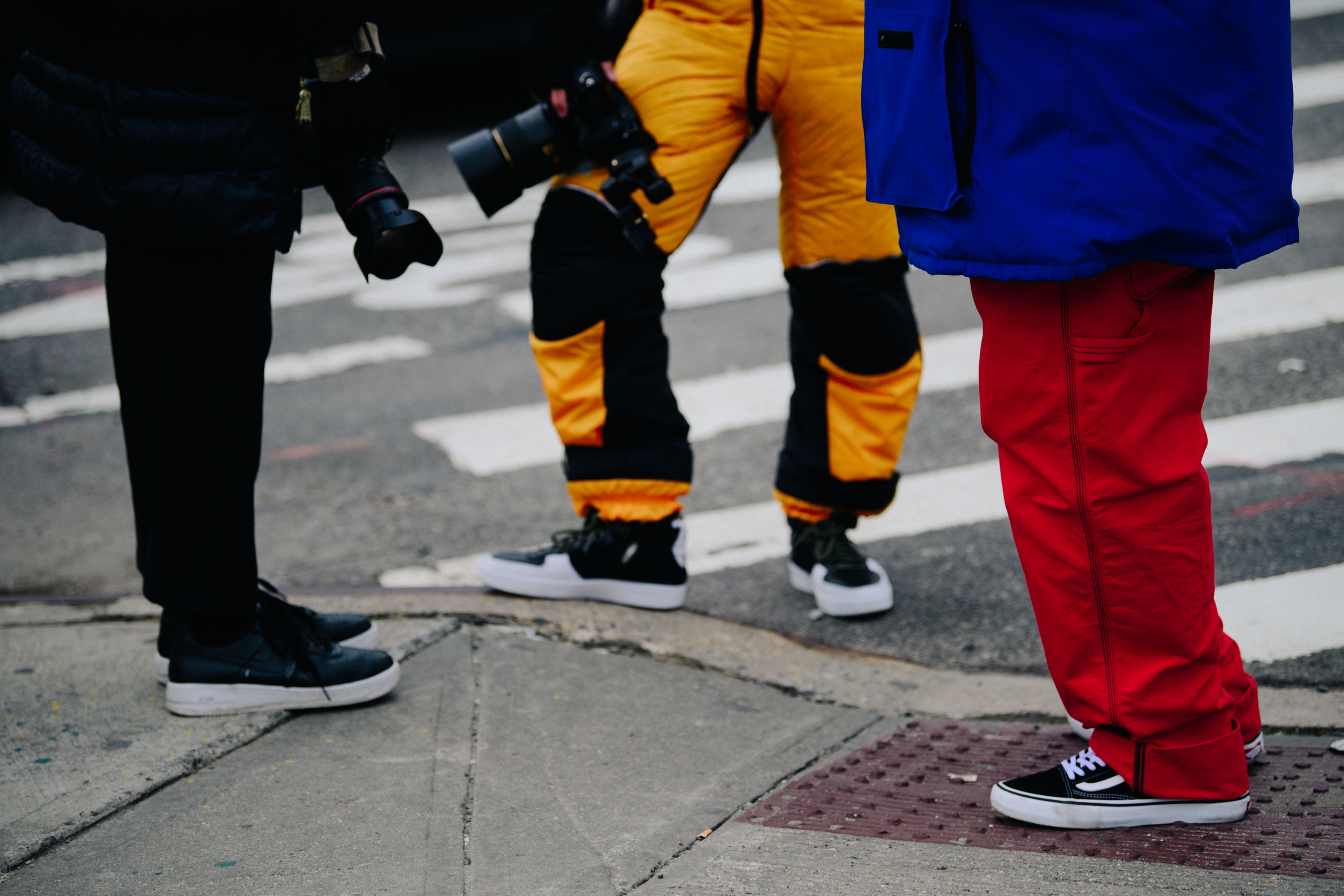 Three men wearing colourful pants