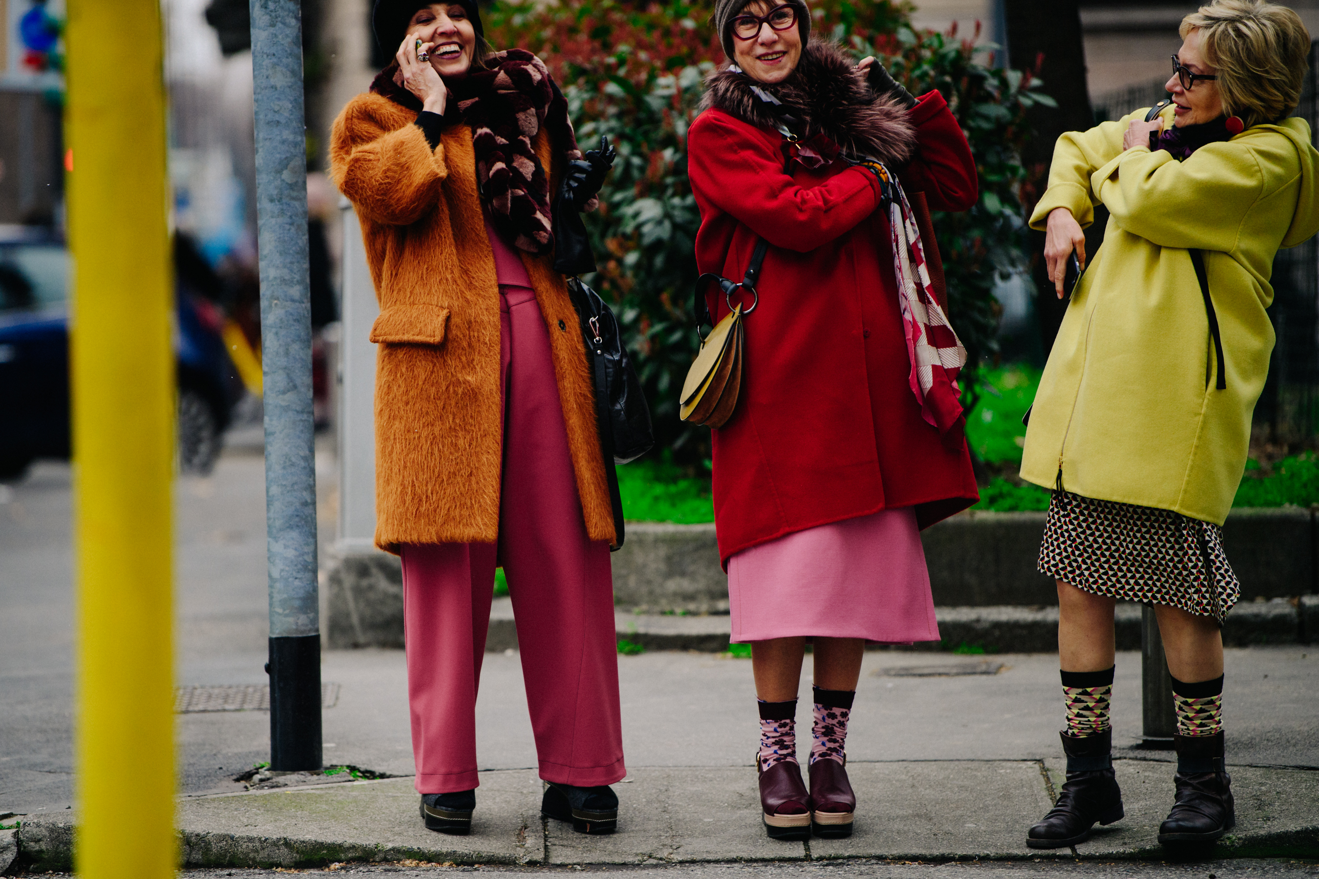 Three women wearing colourful coats