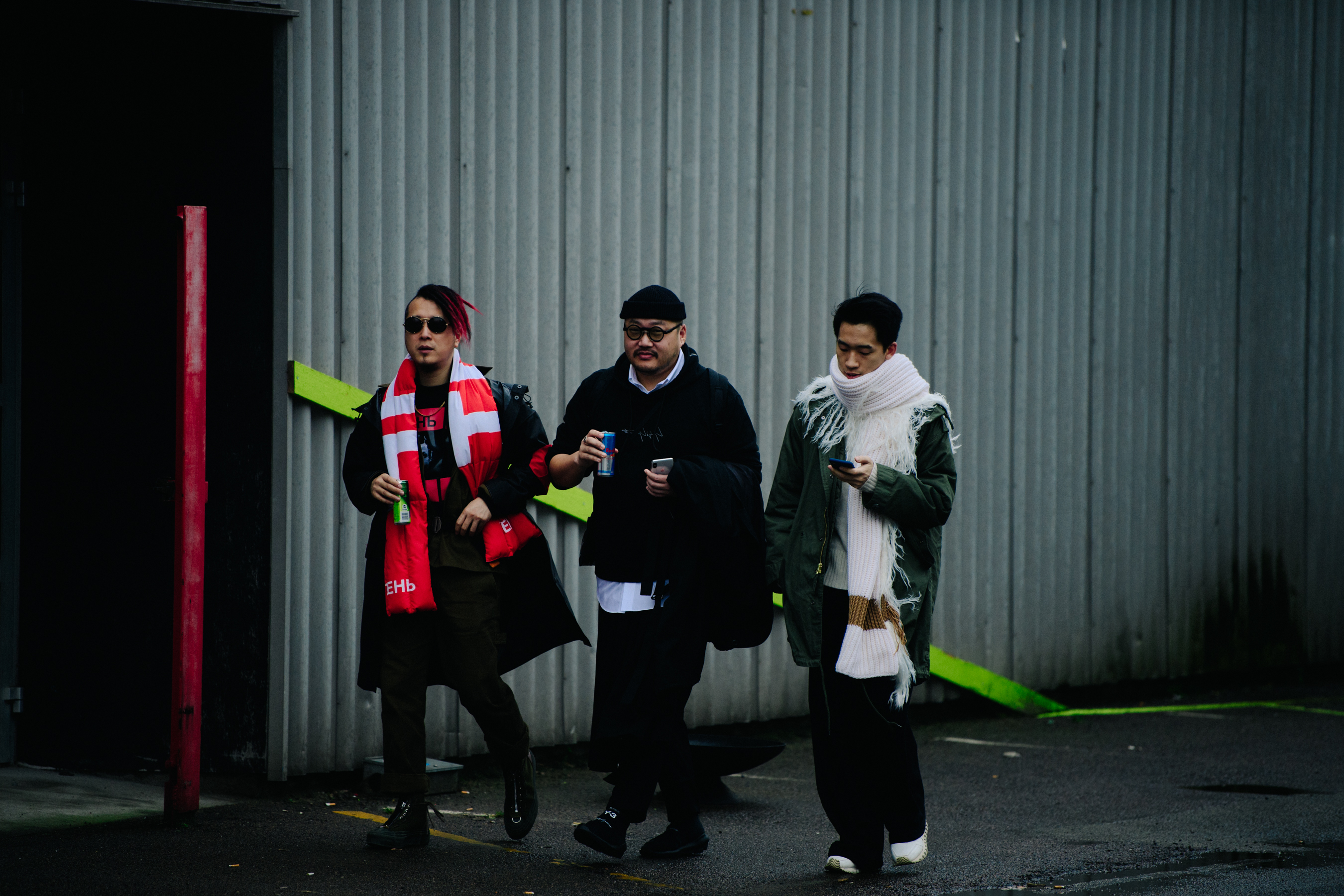 Three Asian men leaving show wearing scarves