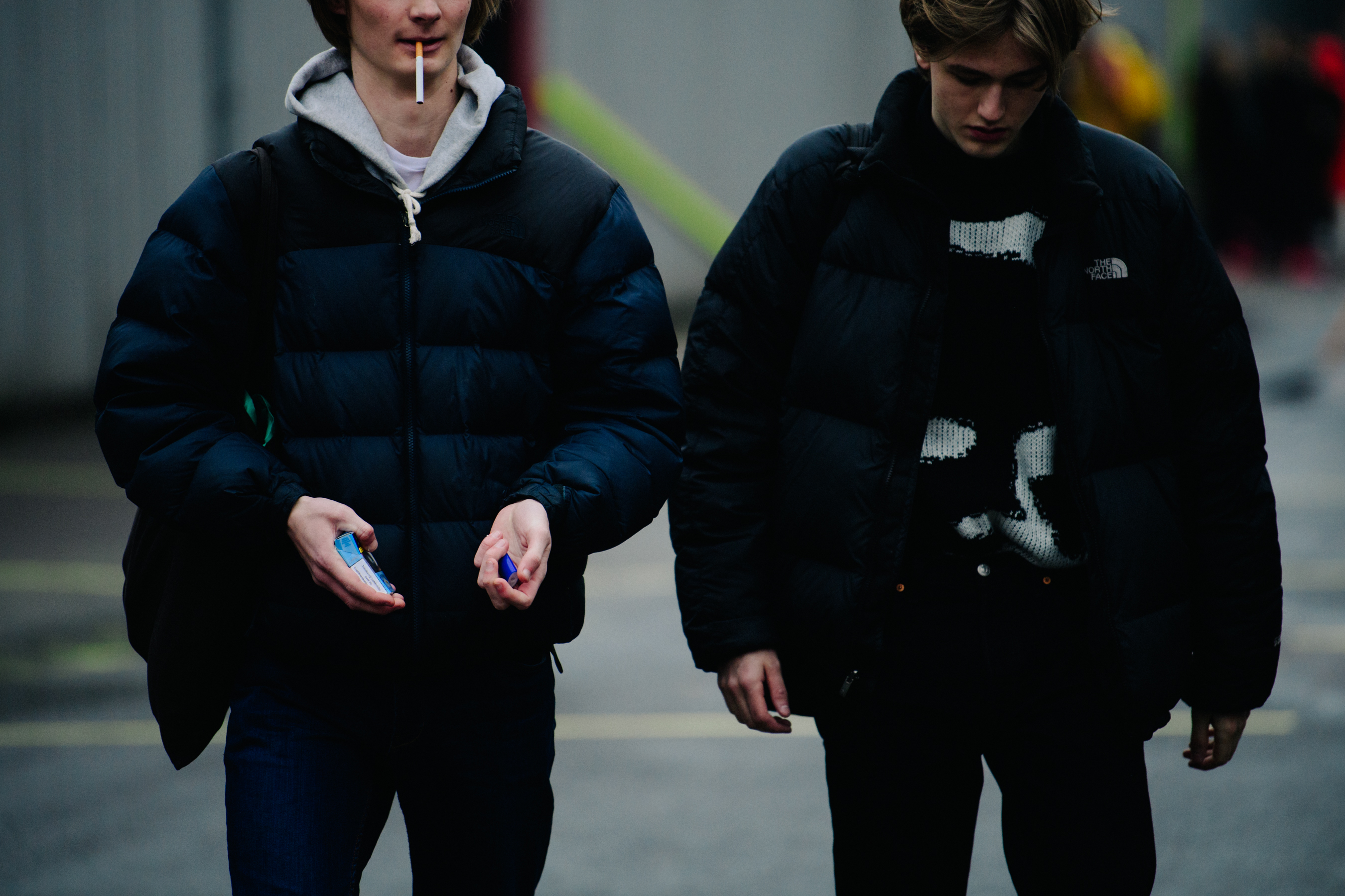 Two models wearing black puffer jackets