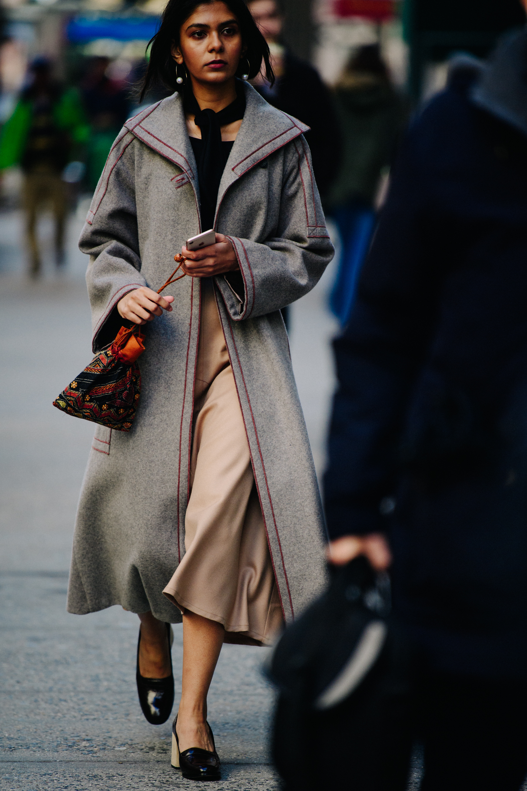 Woman wearing long grey coat