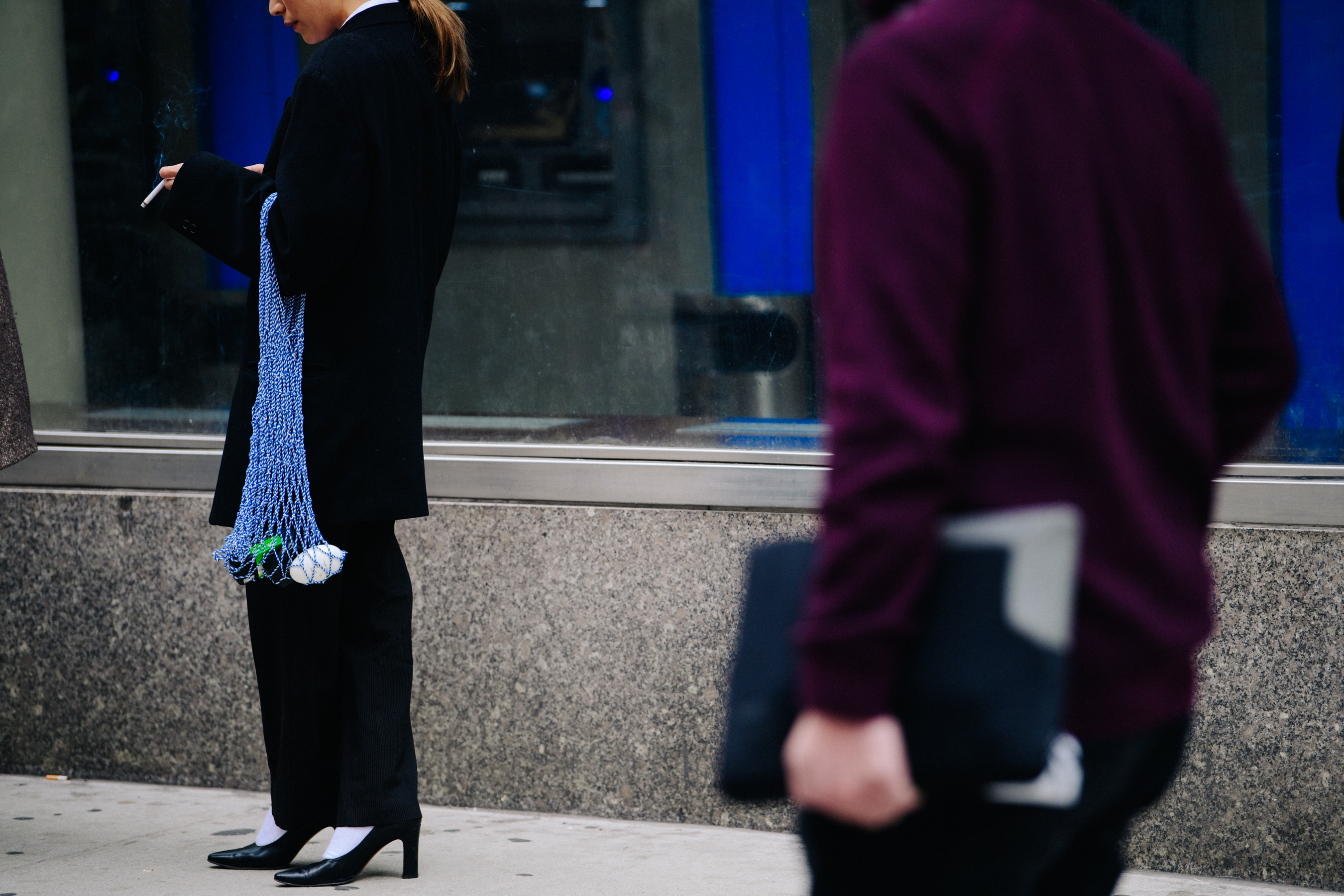 Woman carrying long blue net bag