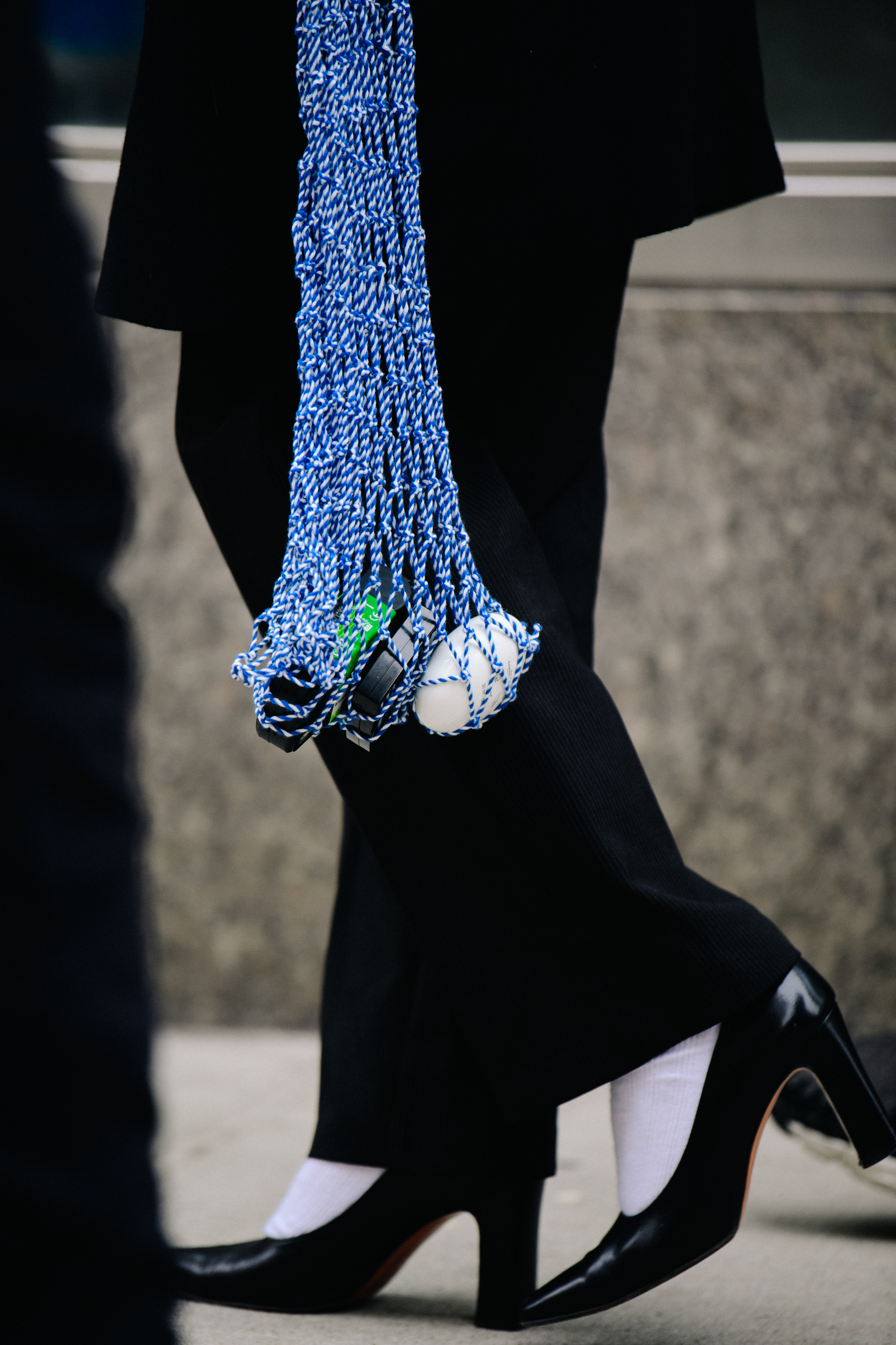 Woman carrying long blue net bag