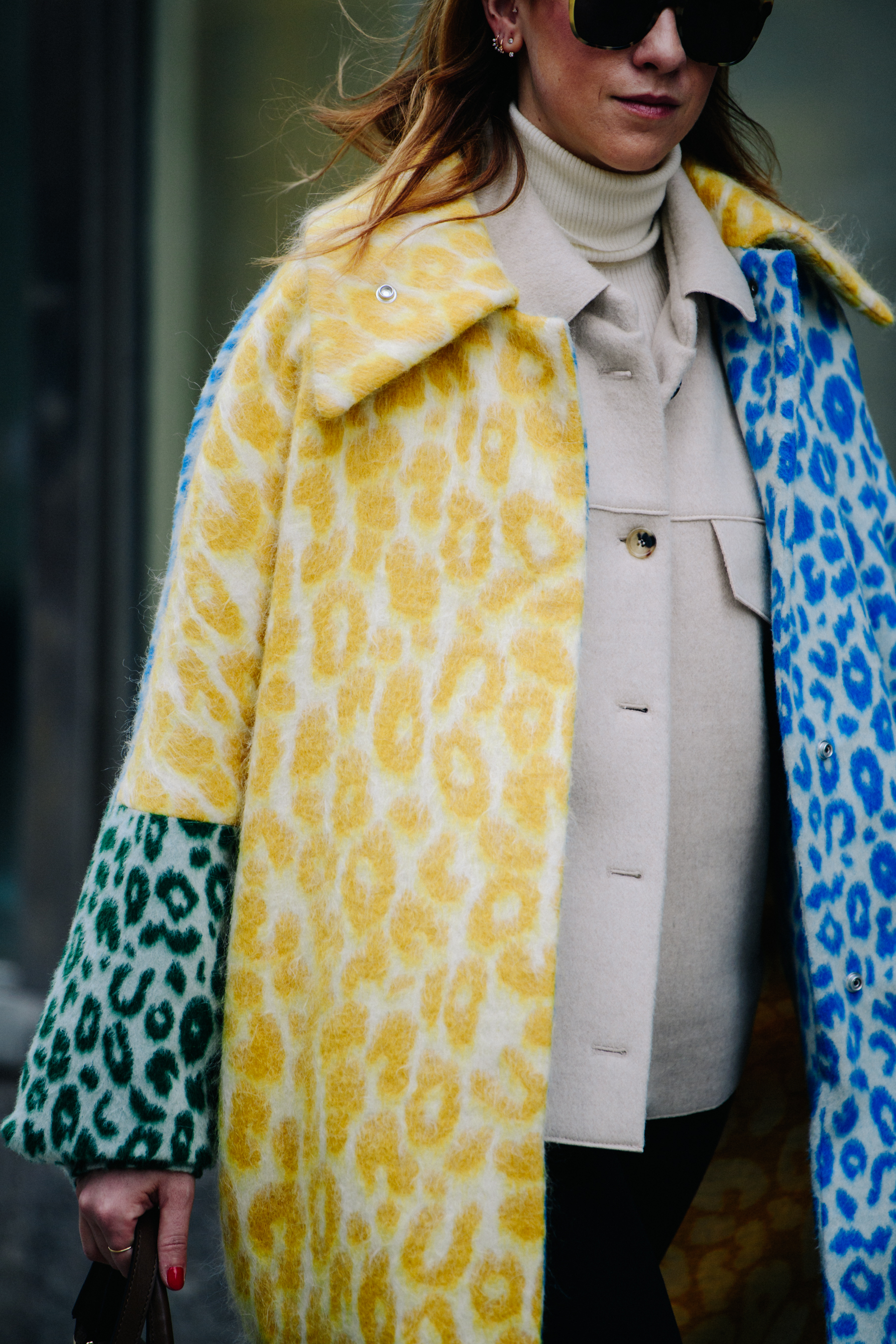 Woman wearing colourful animal print coat