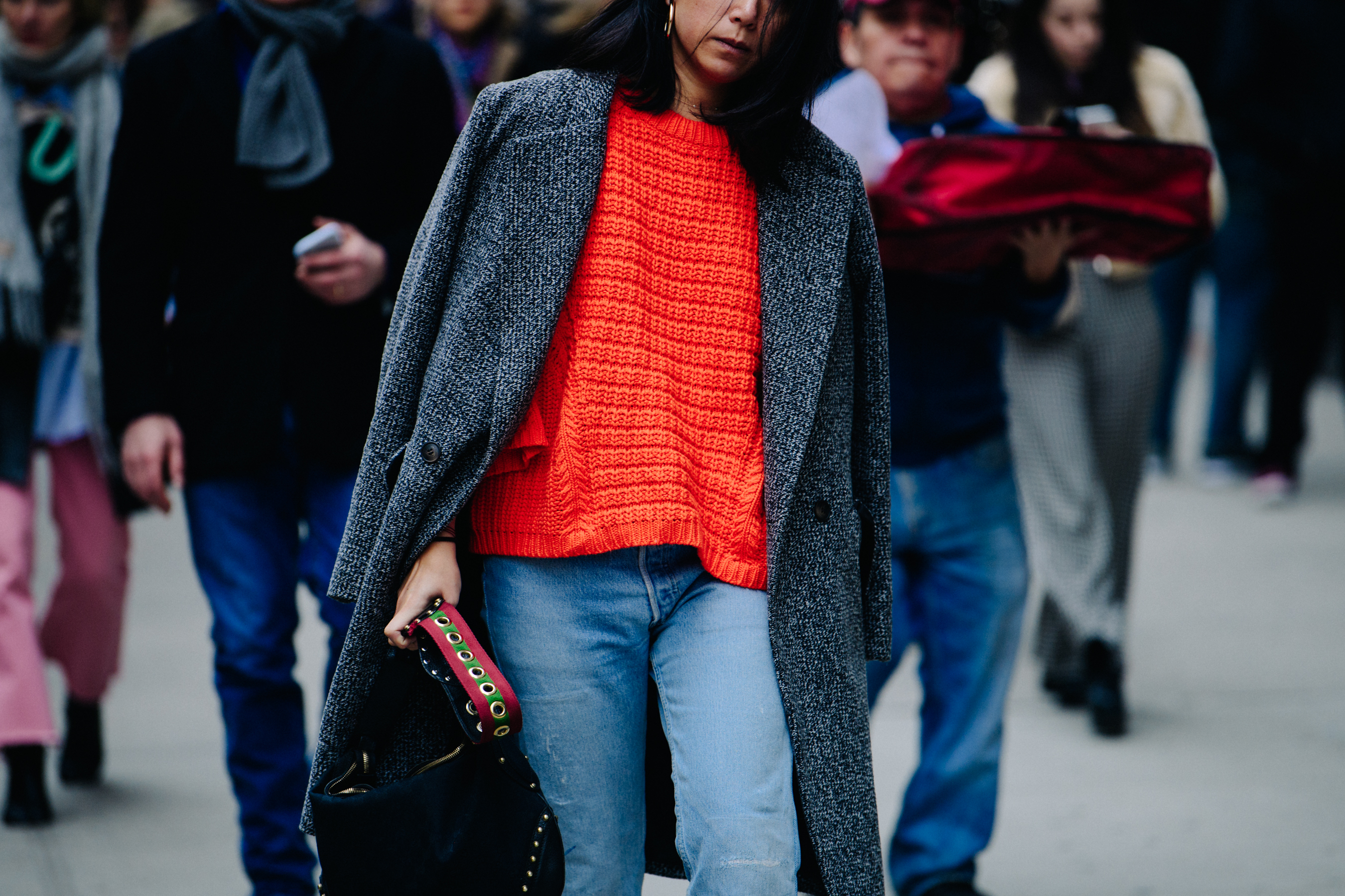 Woman wearing bright orange sweater