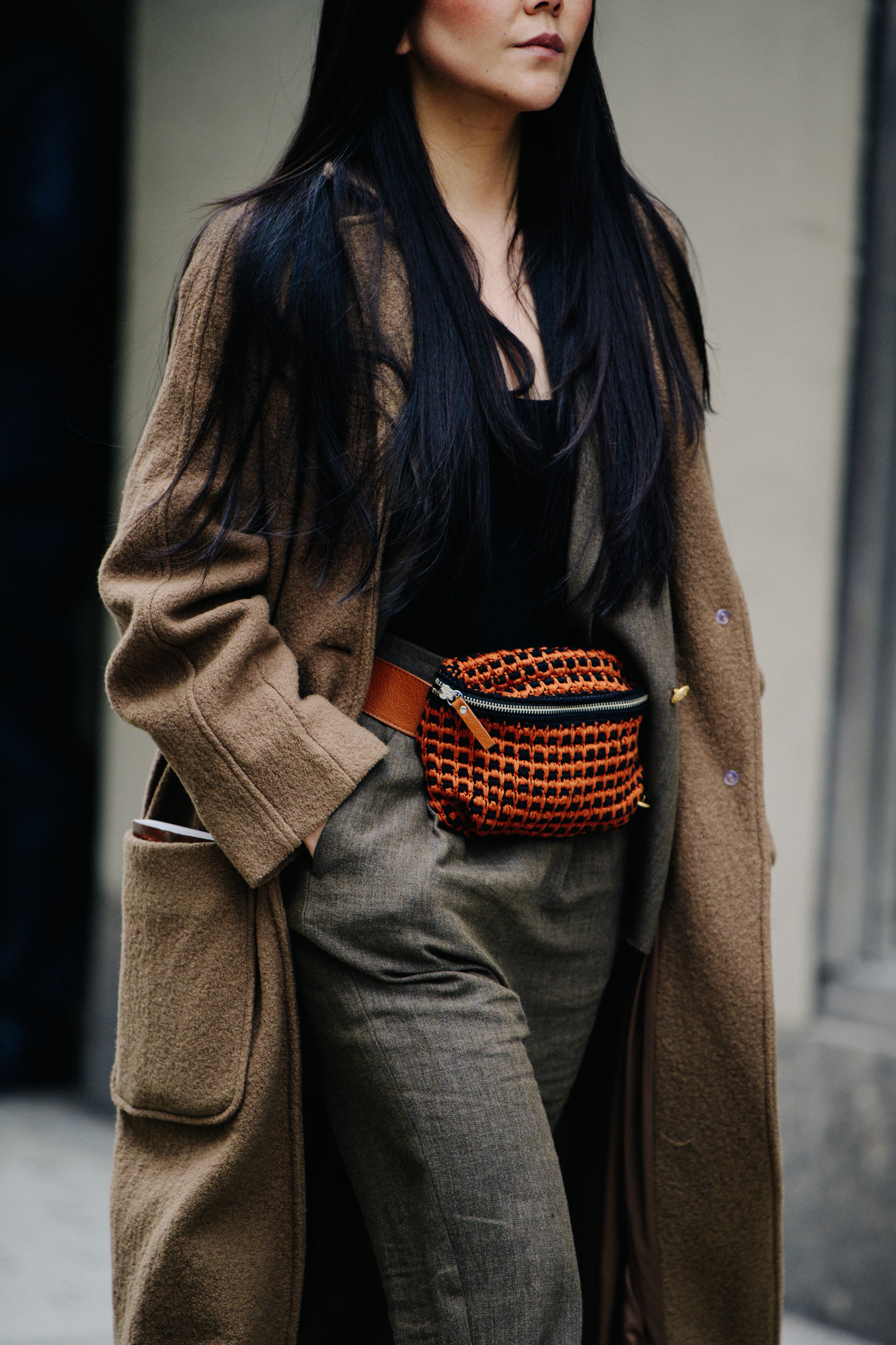 Woman wearing long brown coat