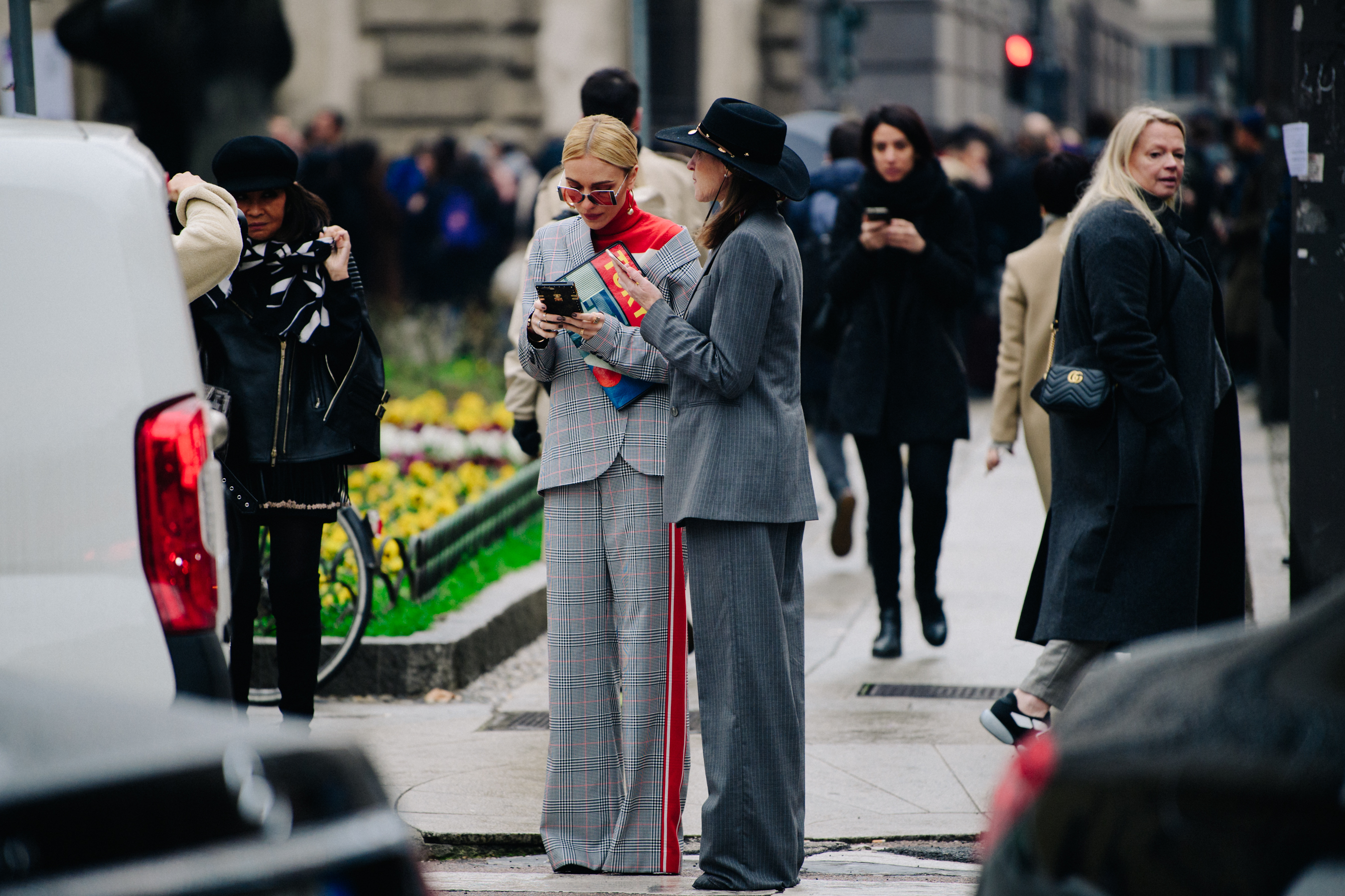 Two women wearing grey suits