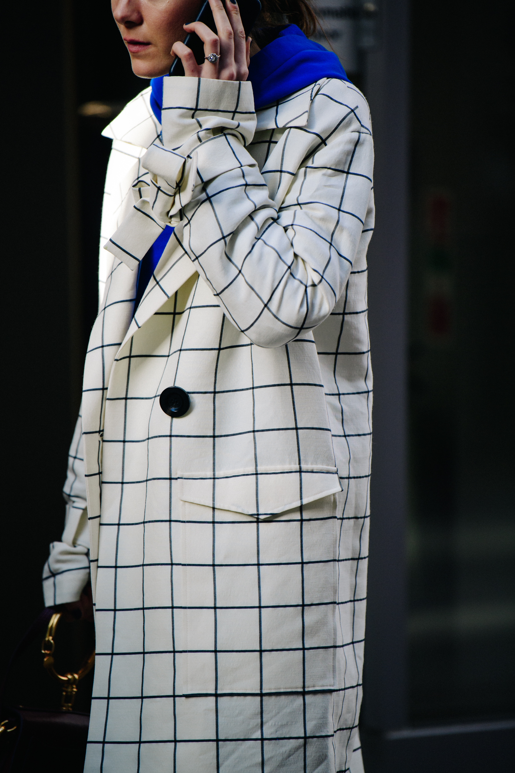 Woman wearing white check coat