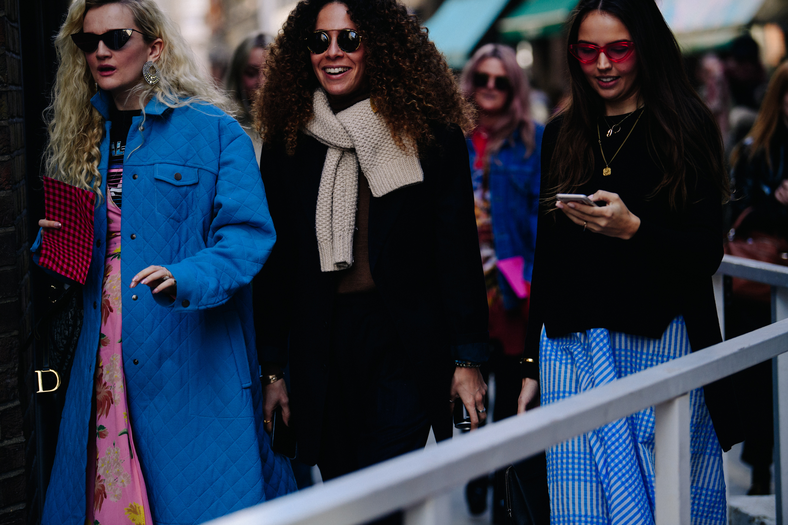 Three women wearing blue and black