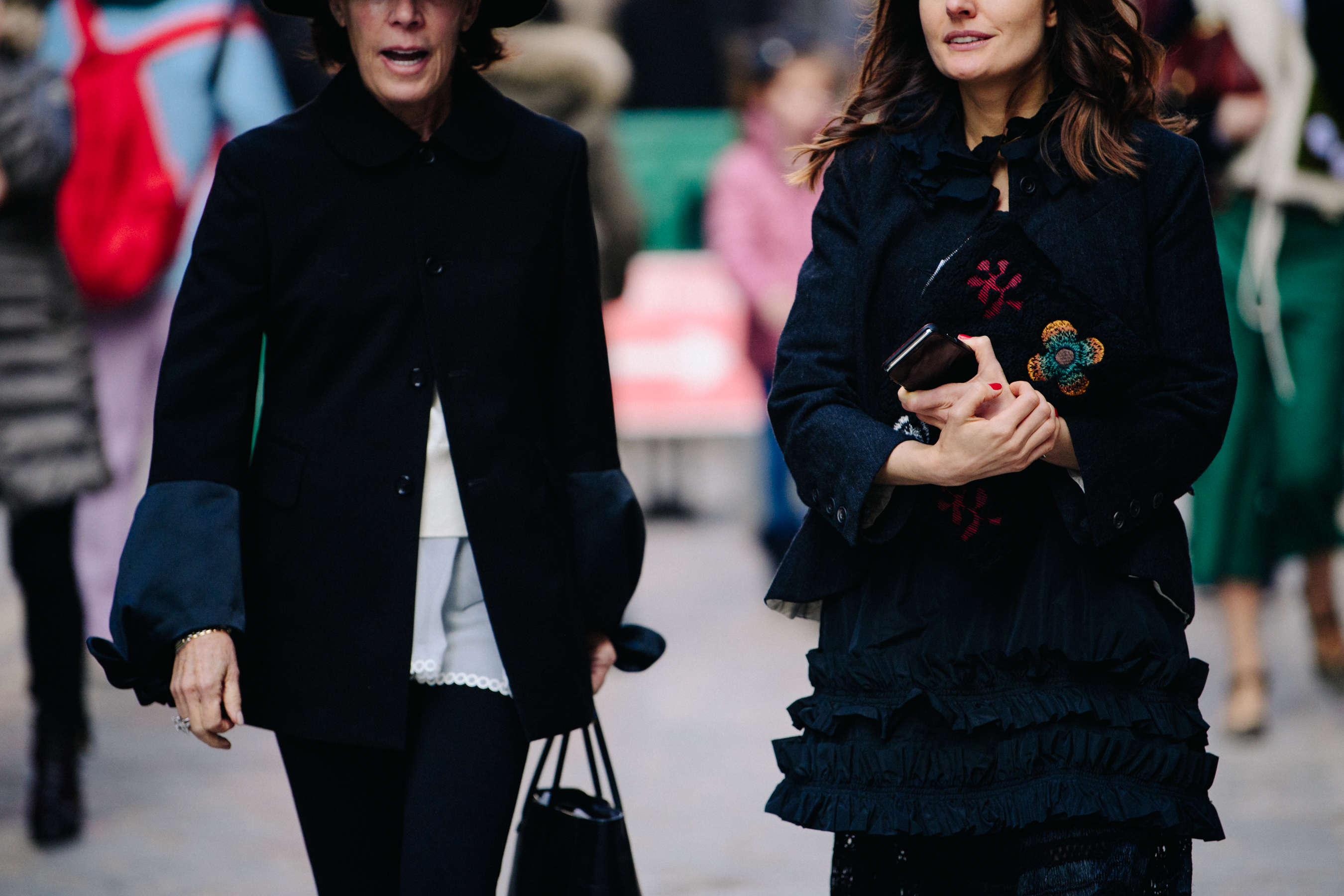 Two women wearing black outfits