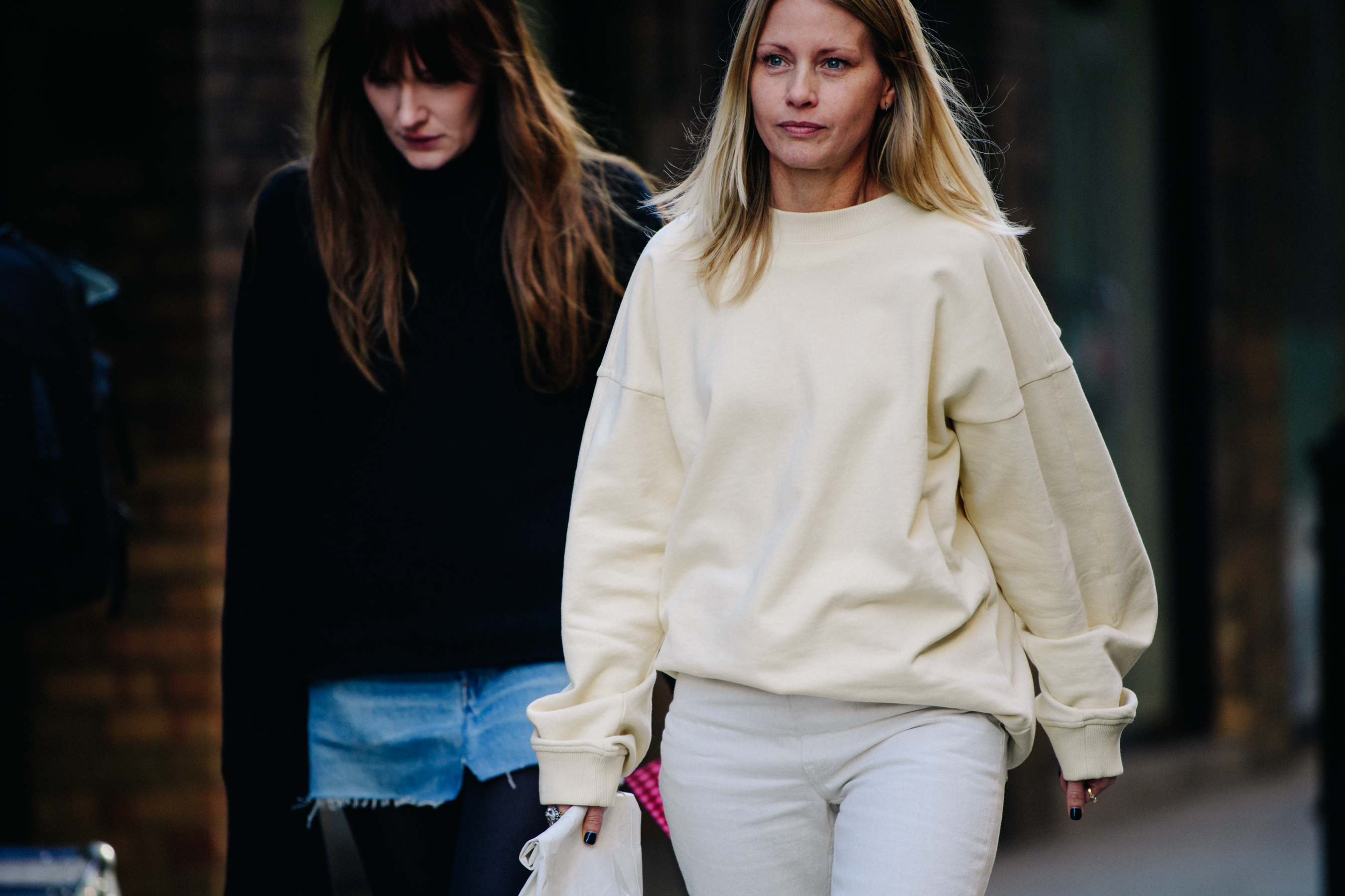 Two women wearing white and black