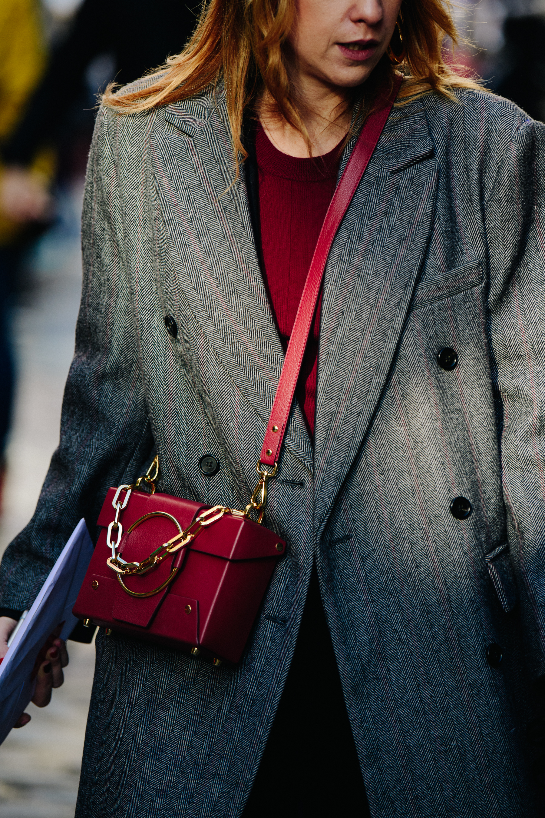 Woman carrying red handbag