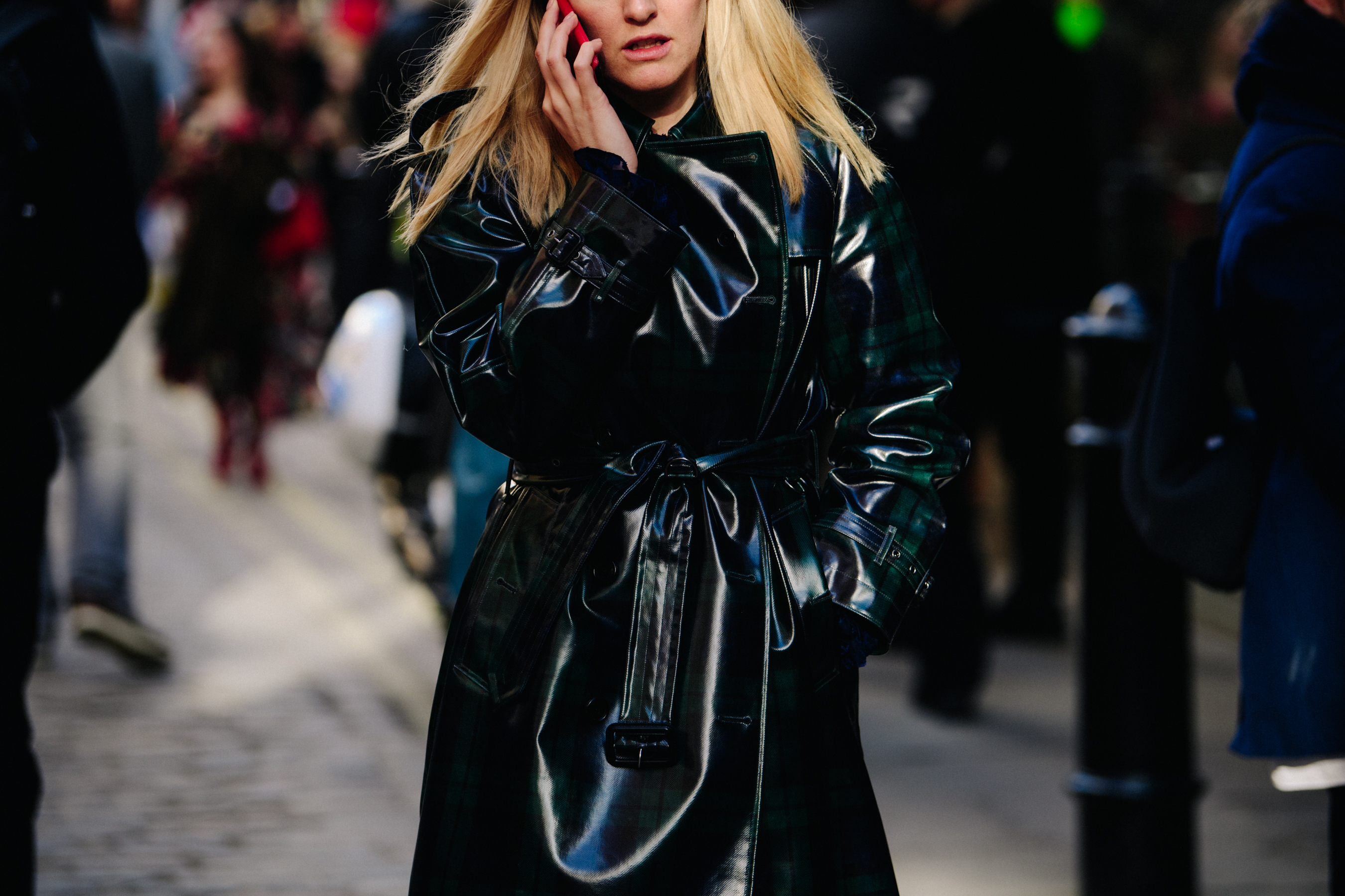 Woman wearing black patent coat