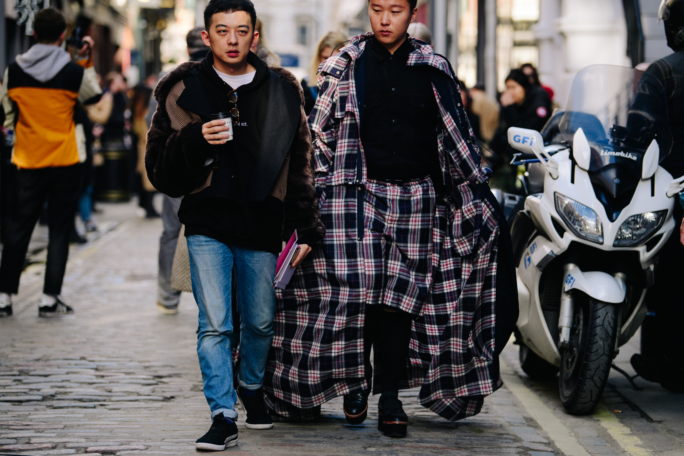 Two Asian men wearing hooded outfits