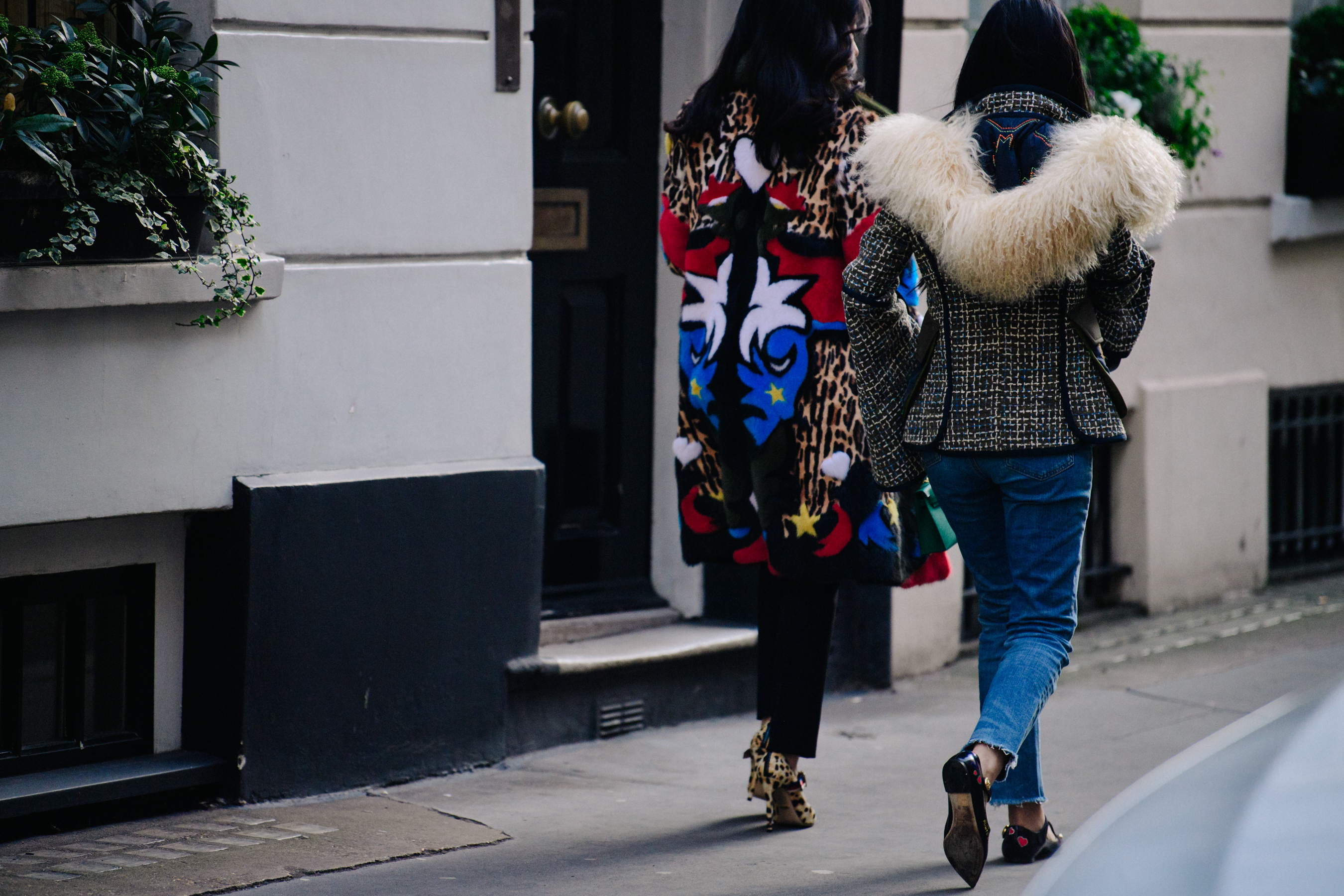 Two women wearing fur jackets