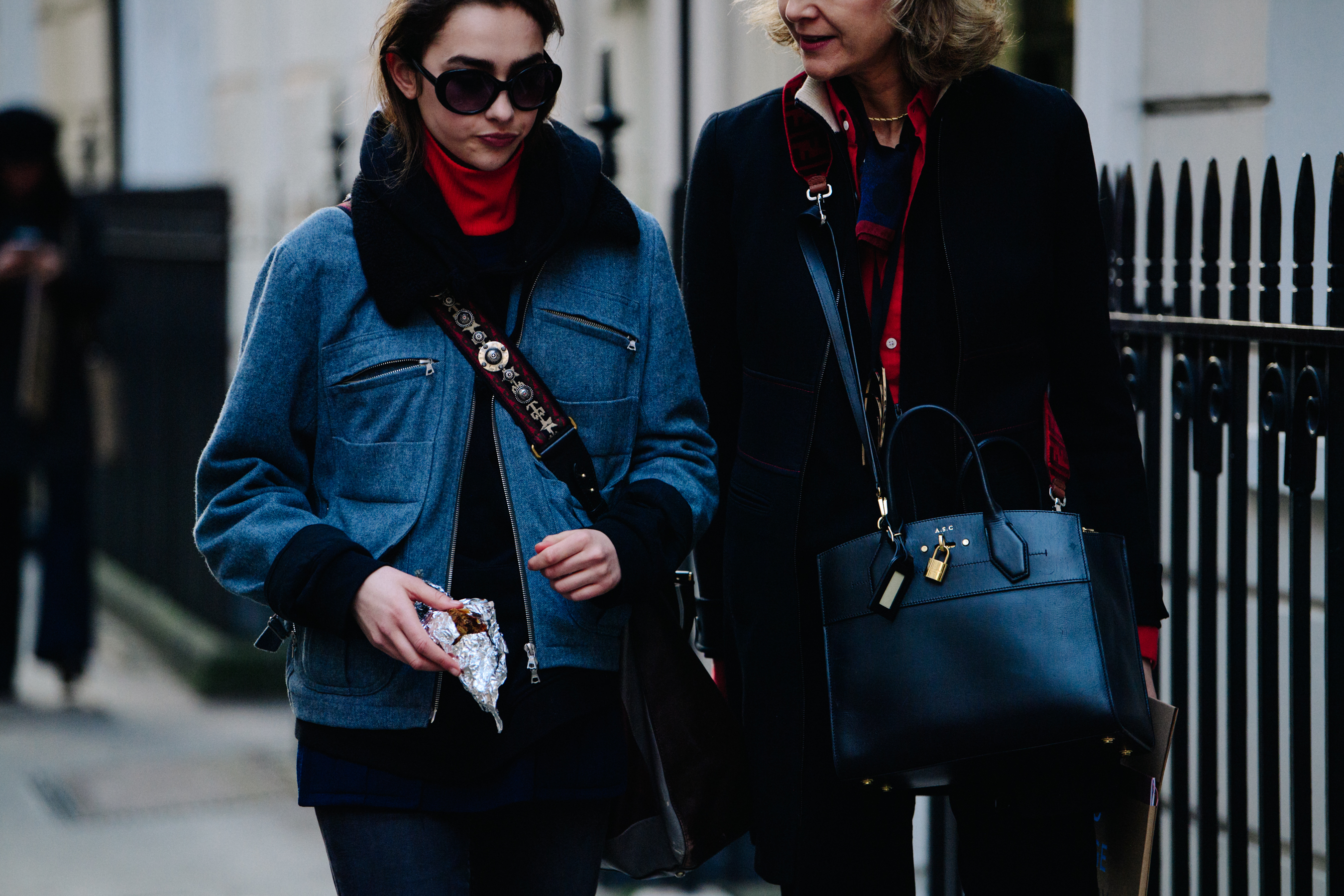 Two women carrying shoulder bags