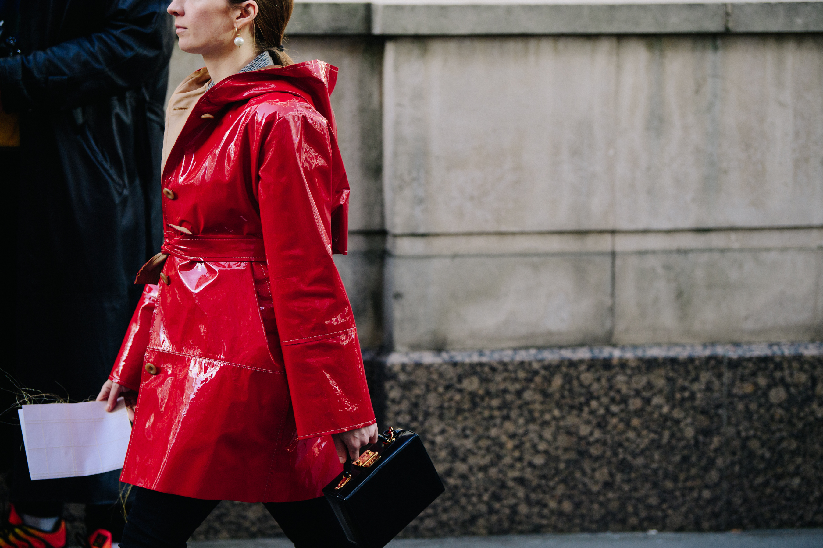 Woman wearing red patent coat