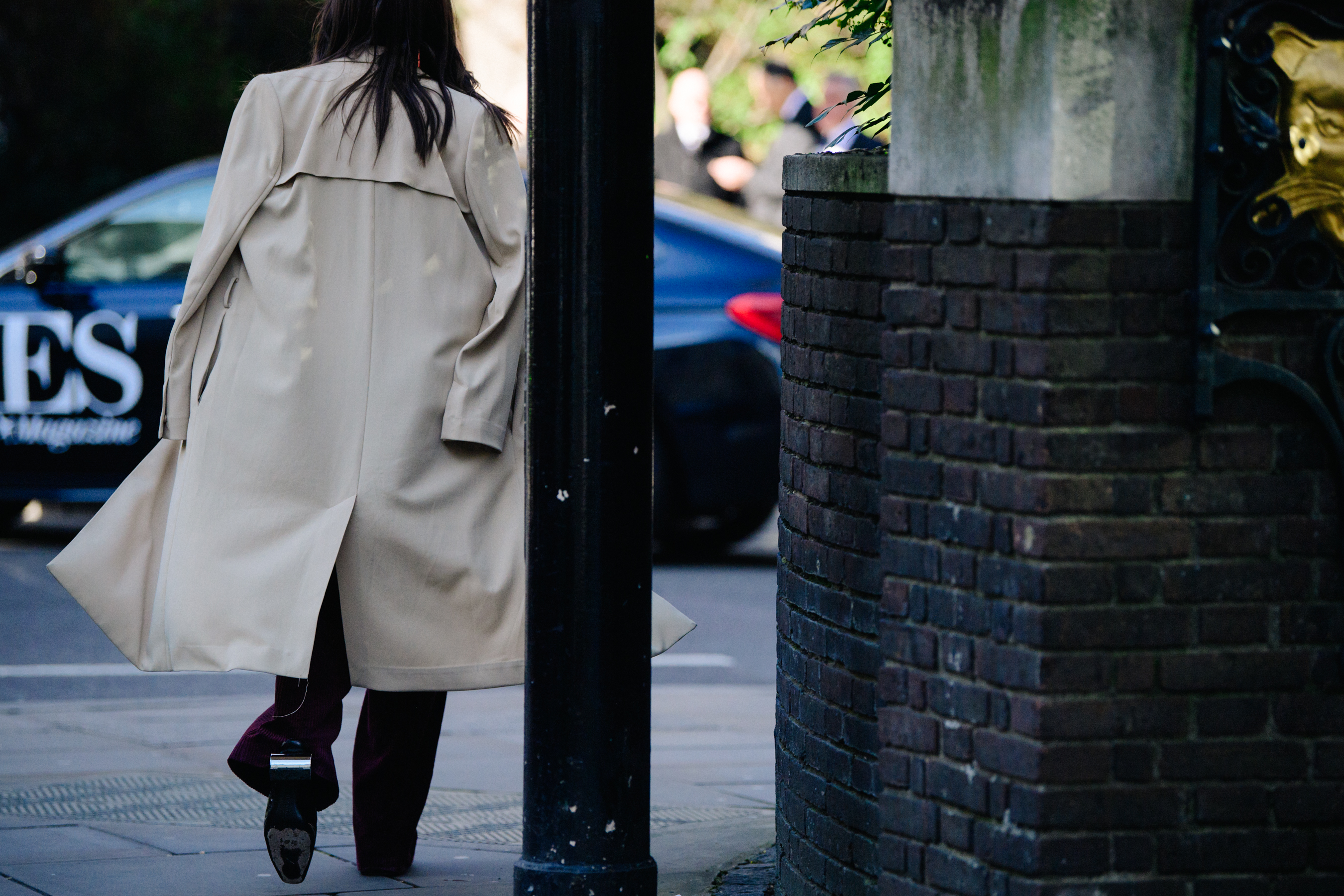 Woman wearing long tan coat