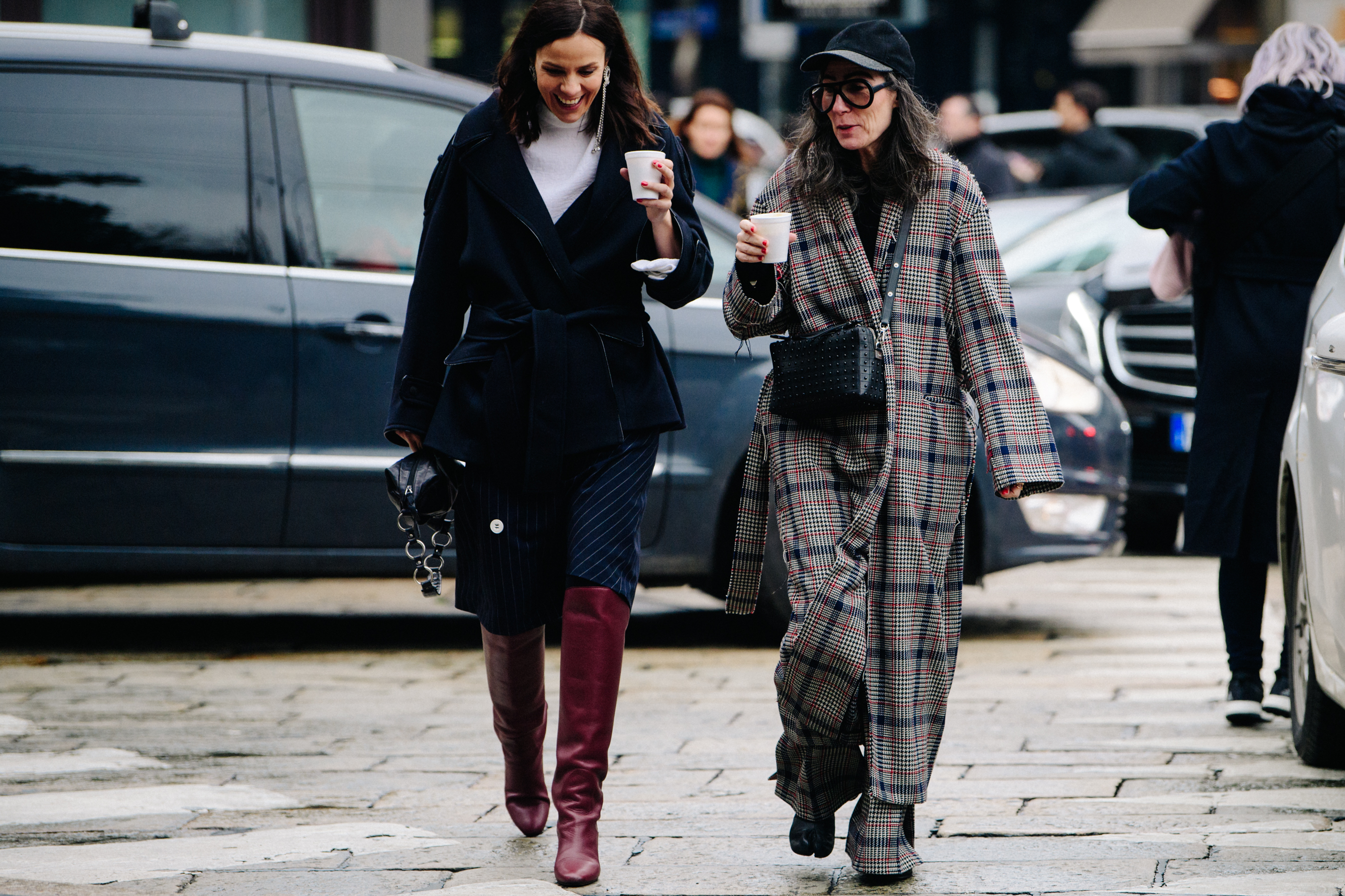 Two women wearing dark outfits