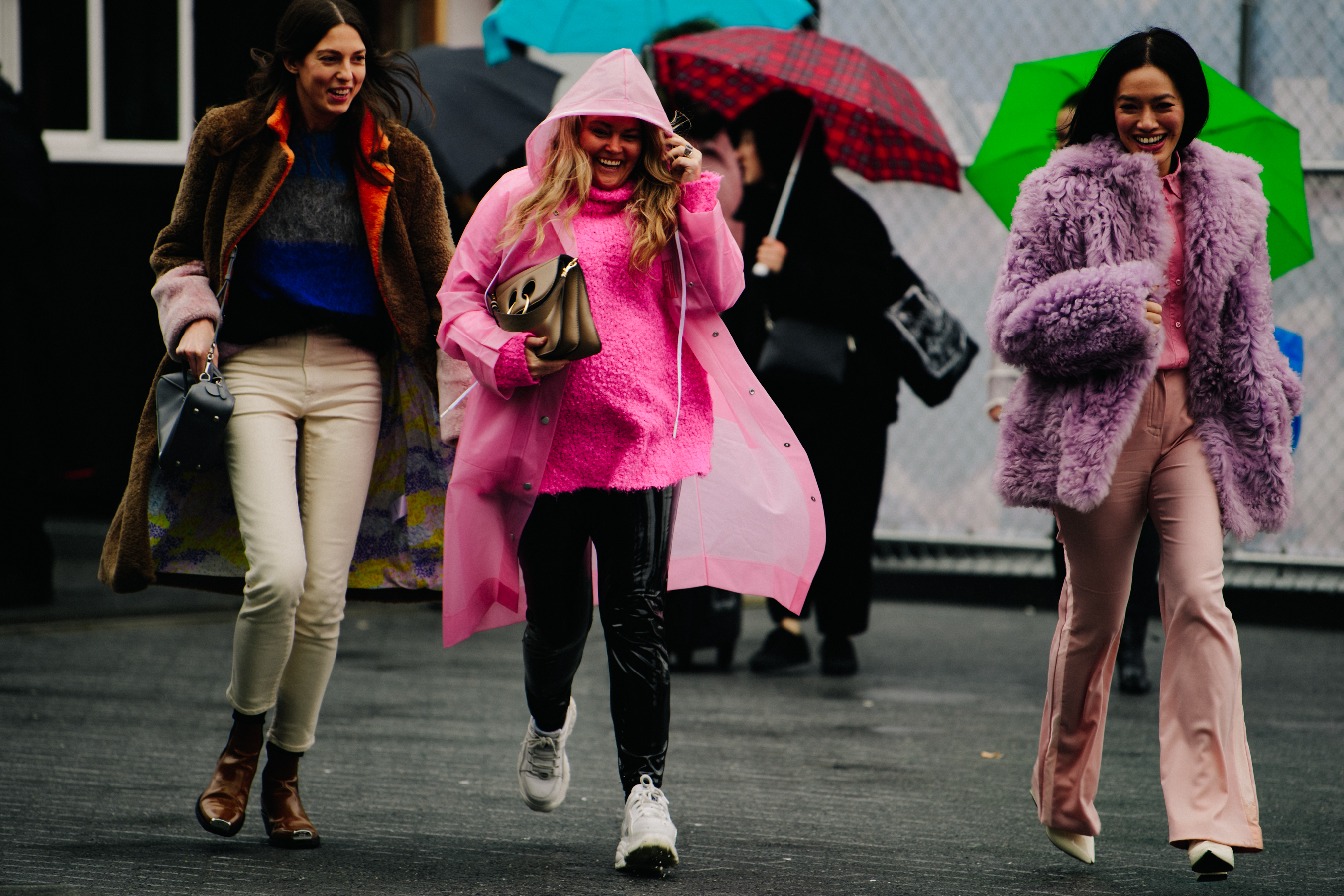 Three women wearing bright fur outfits