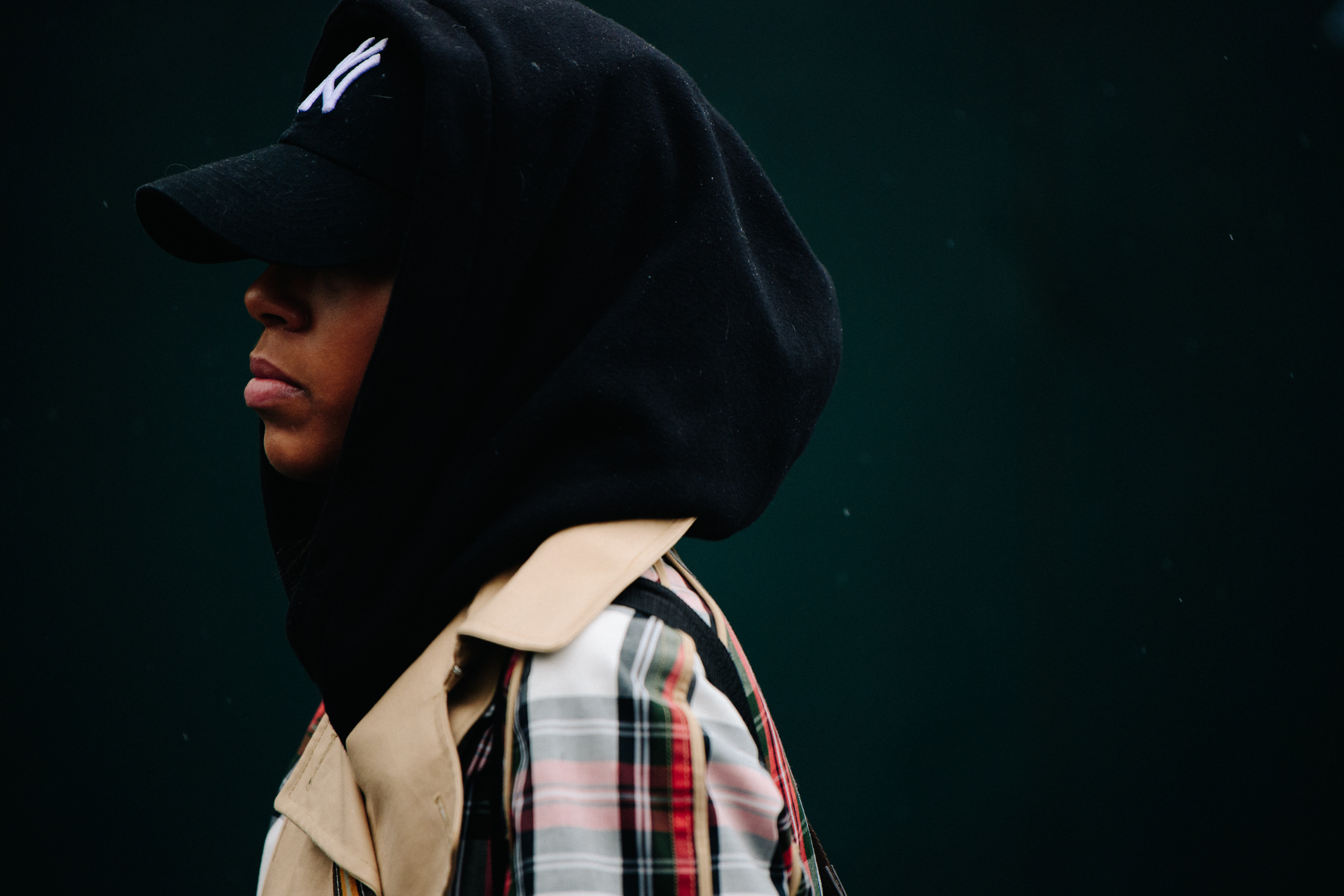 Woman wearing black cap and hoodie